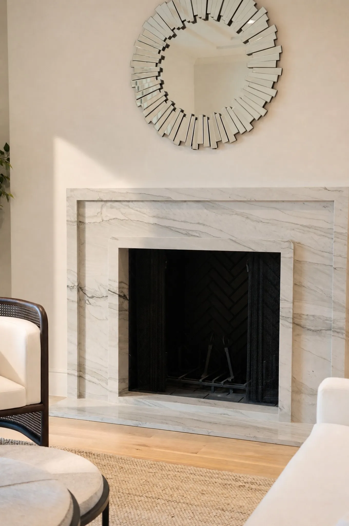 Fireplace featuring a stone surround and hearth, with a black herringbone pattern firebox