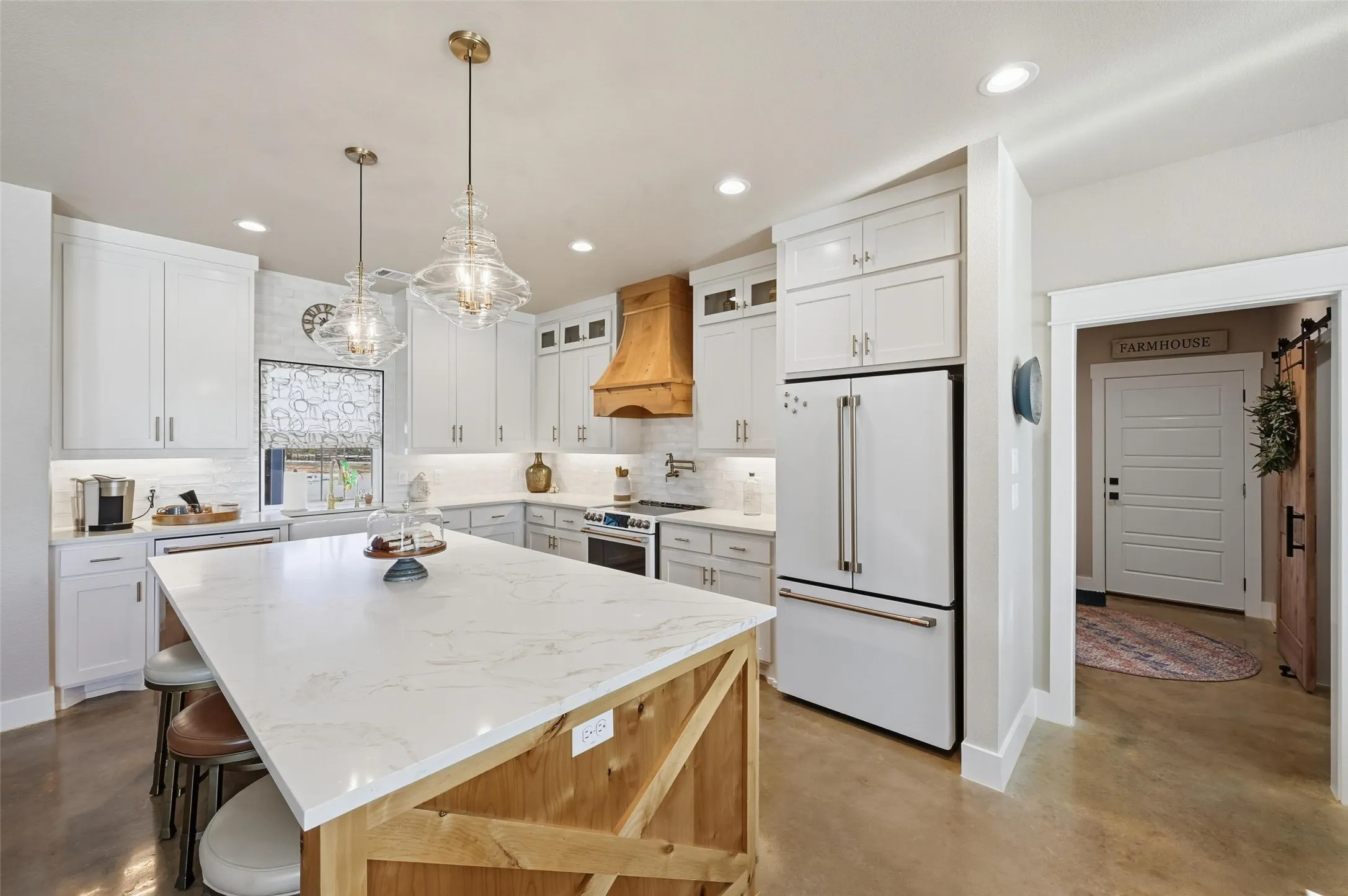 Kitchen featuring concrete floors, decorative backsplash, glass insert cabinets, white appliances, and recessed lighting