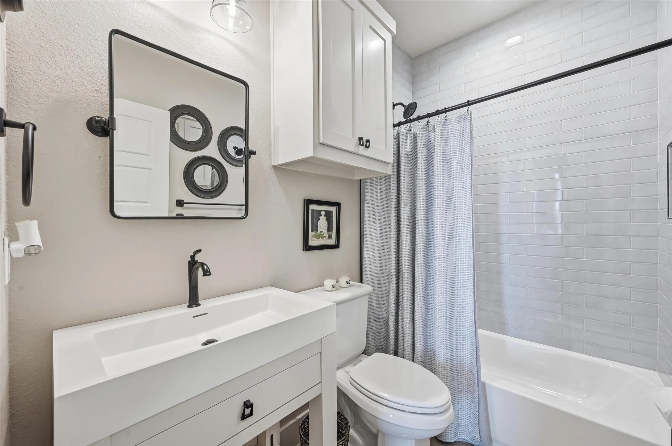 Bathroom with shower / tub combo with curtain and vanity