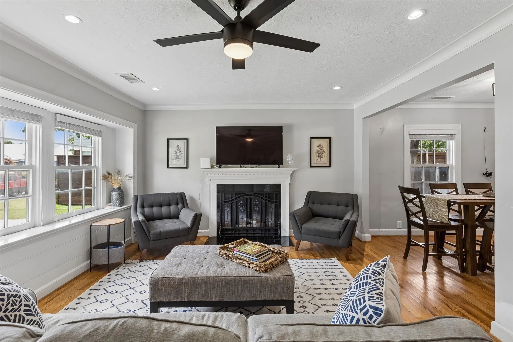Hardwood flooring throughout, recessed lighting, and a ceiling fan