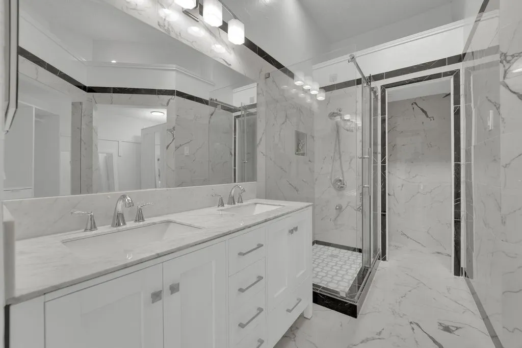 Dual vanity with white cabinetry and chrome hardware