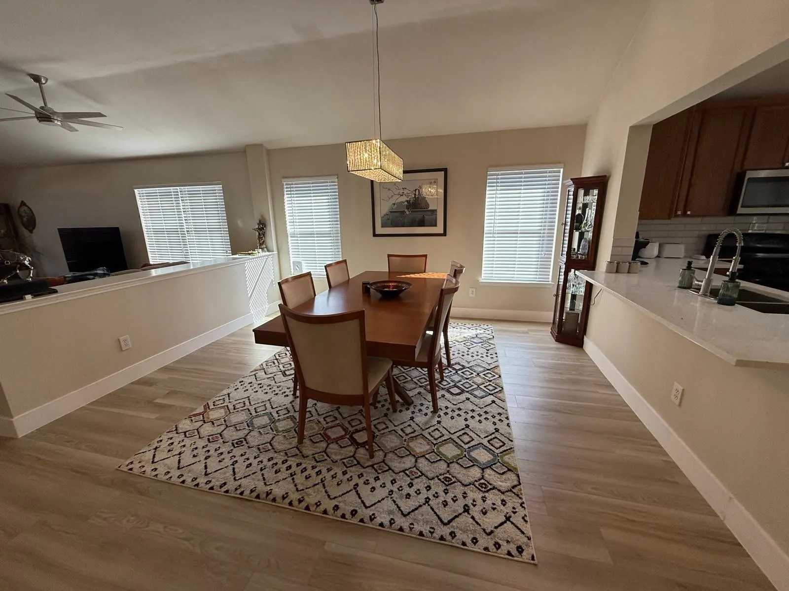 Light wood-finish flooring extending through the space