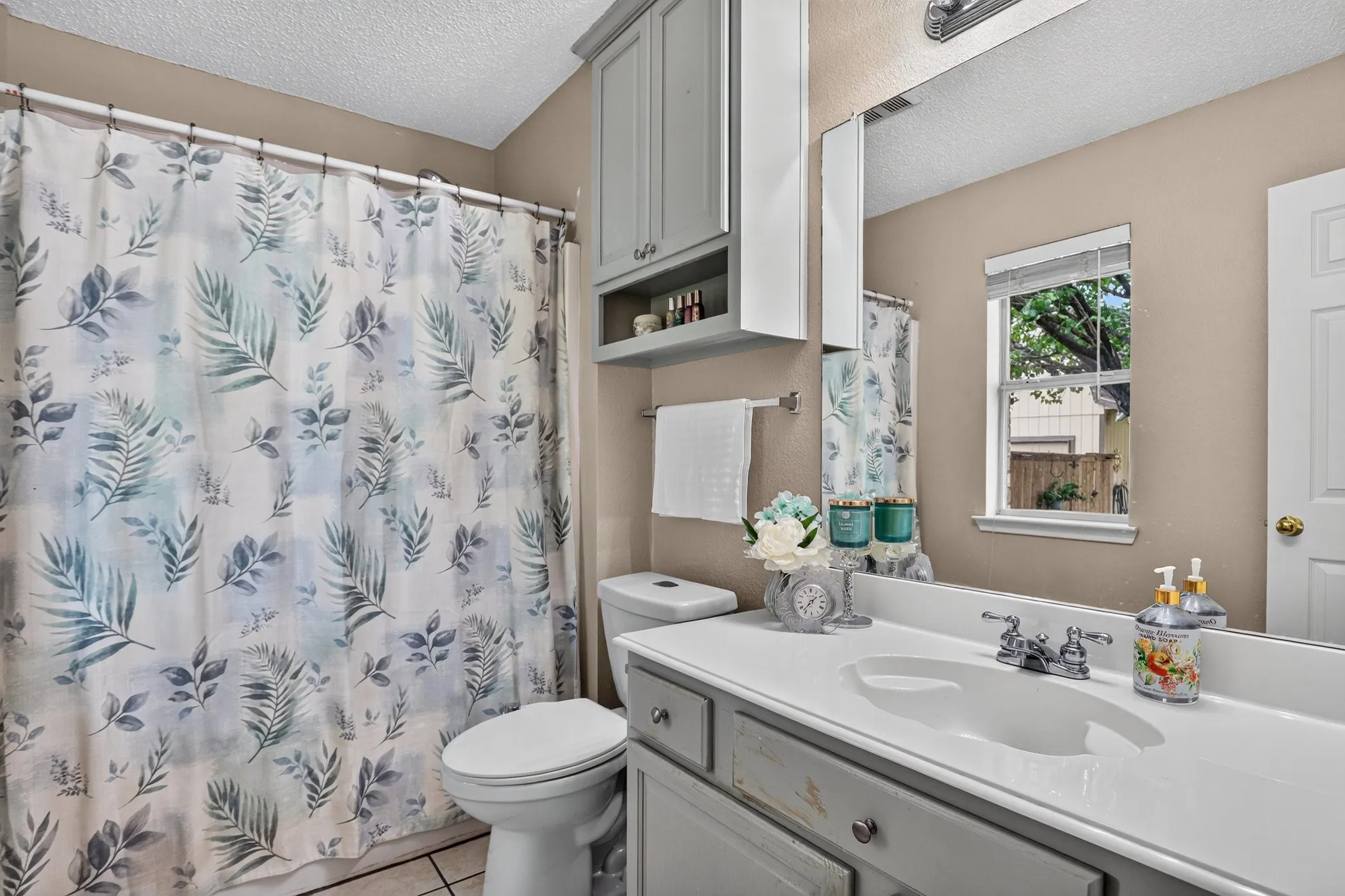 Vanity with integrated sink, chrome faucet, and lower cabinetry