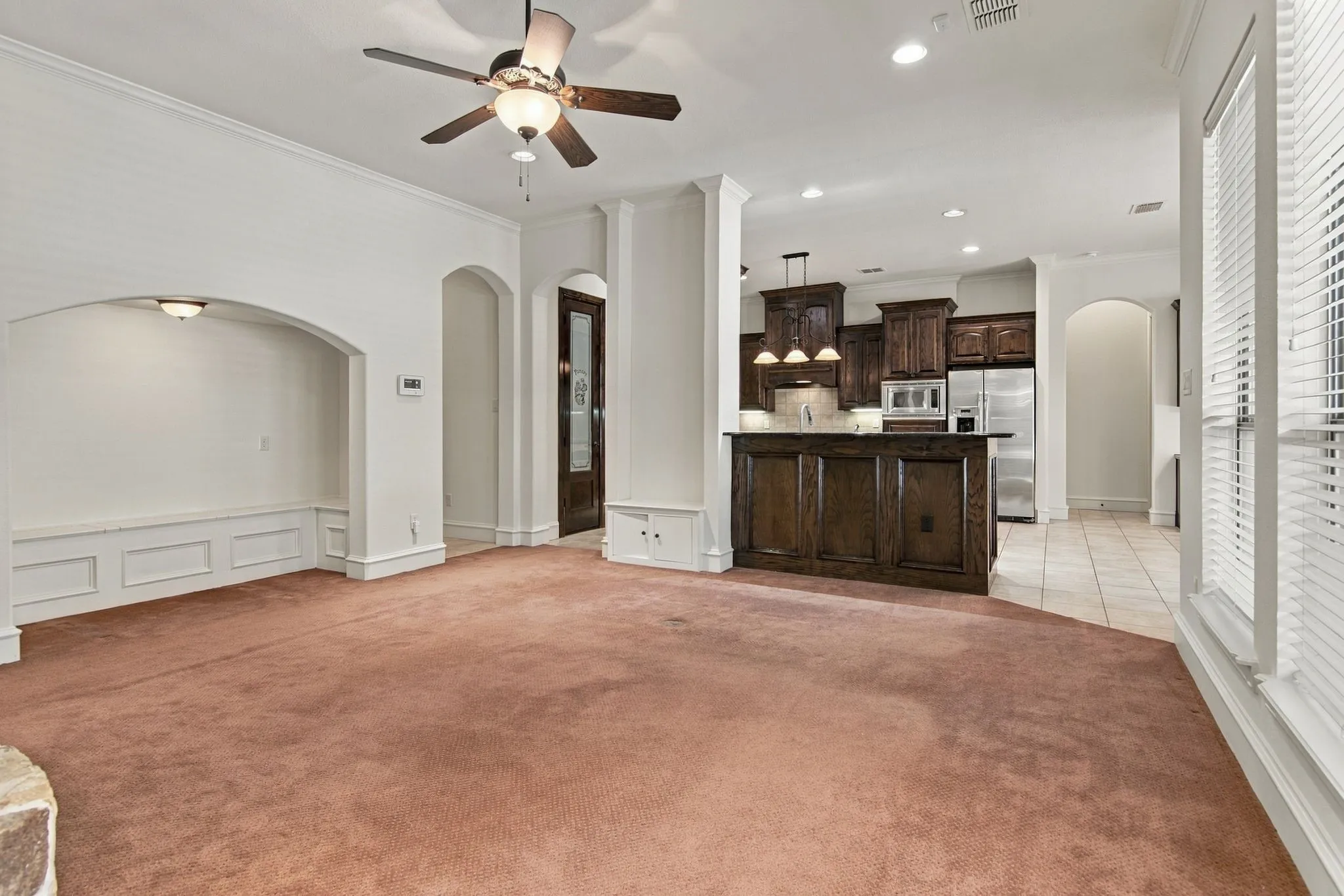 Open-concept layout with recessed lighting and a ceiling fan