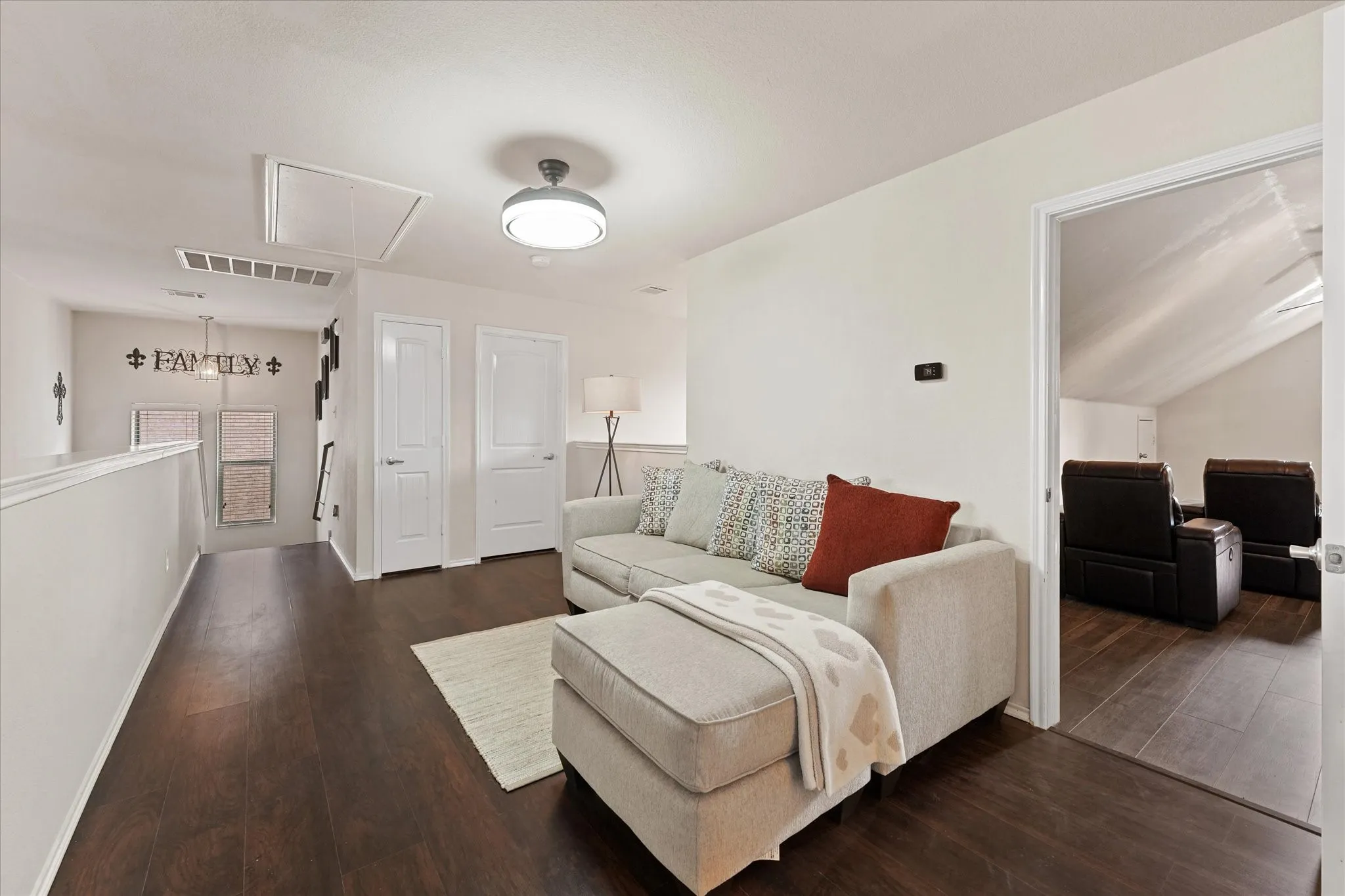 Wood-finish flooring throughout, white interior doors with contemporary hardware, and a semi-flush mount ceiling light fixture
