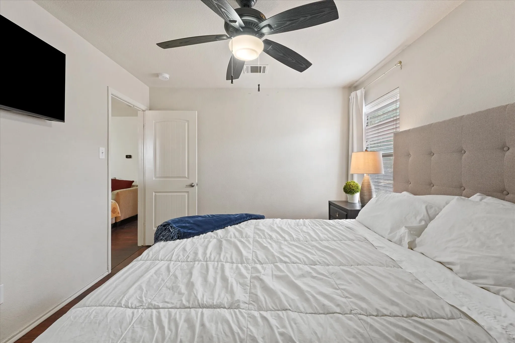 Recessed lighting, ceiling fan with integrated light, wood-finish flooring, white paneled door, and window with blinds
