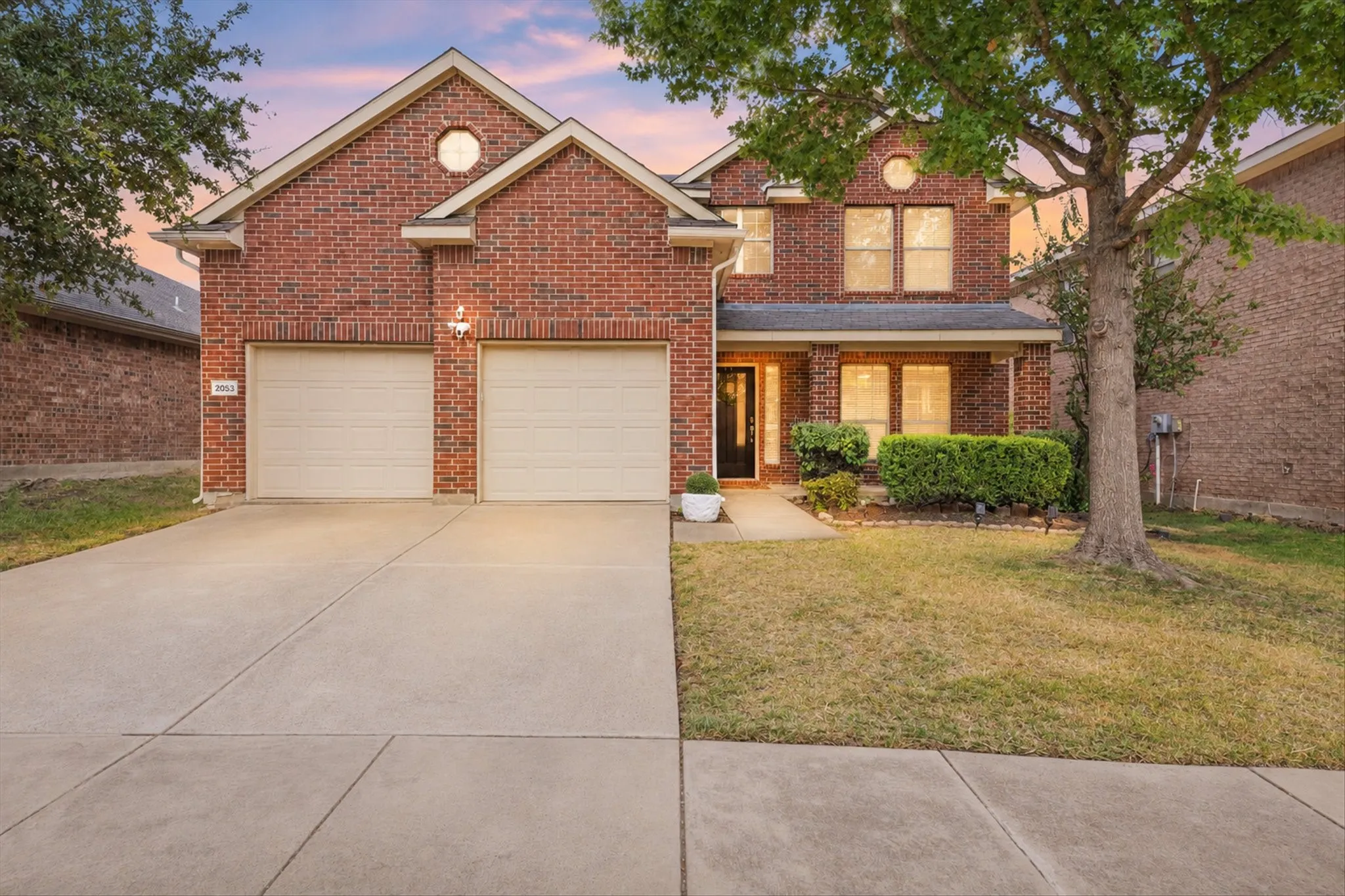 Brick exterior with gabled roof lines and round accent window