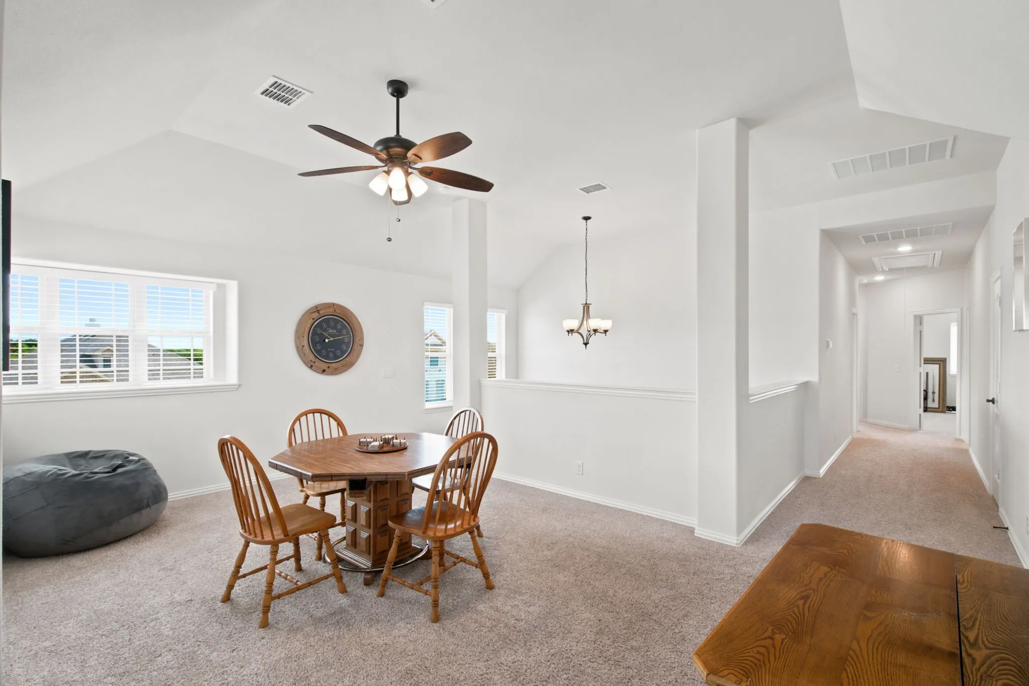 Vaulted ceiling featuring a ceiling fan with integrated lighting