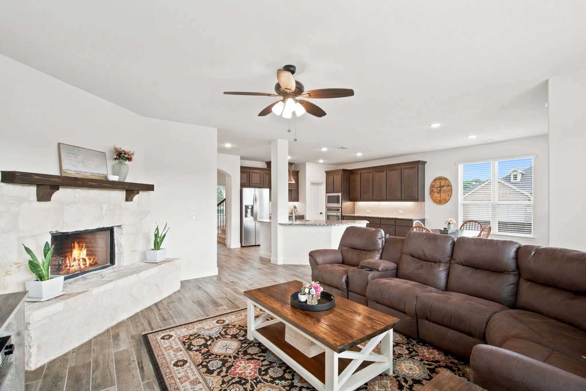 Stone-clad fireplace with wood mantel