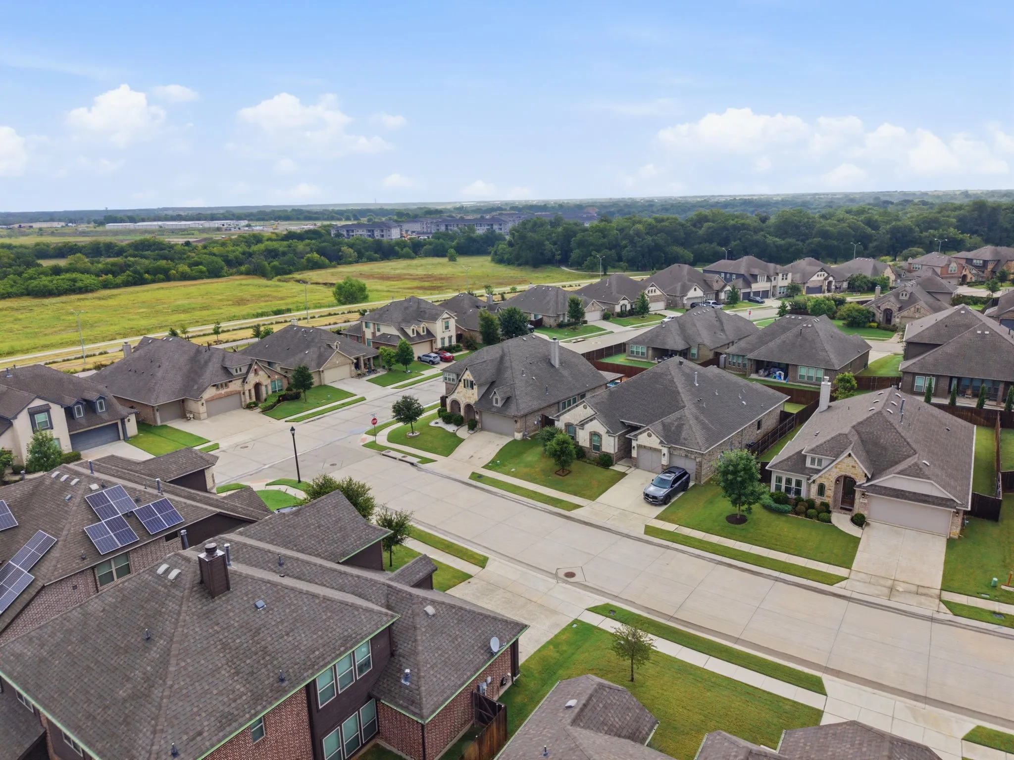 Residential neighborhood featuring mature landscaping, paved streets, and varied architectural styles