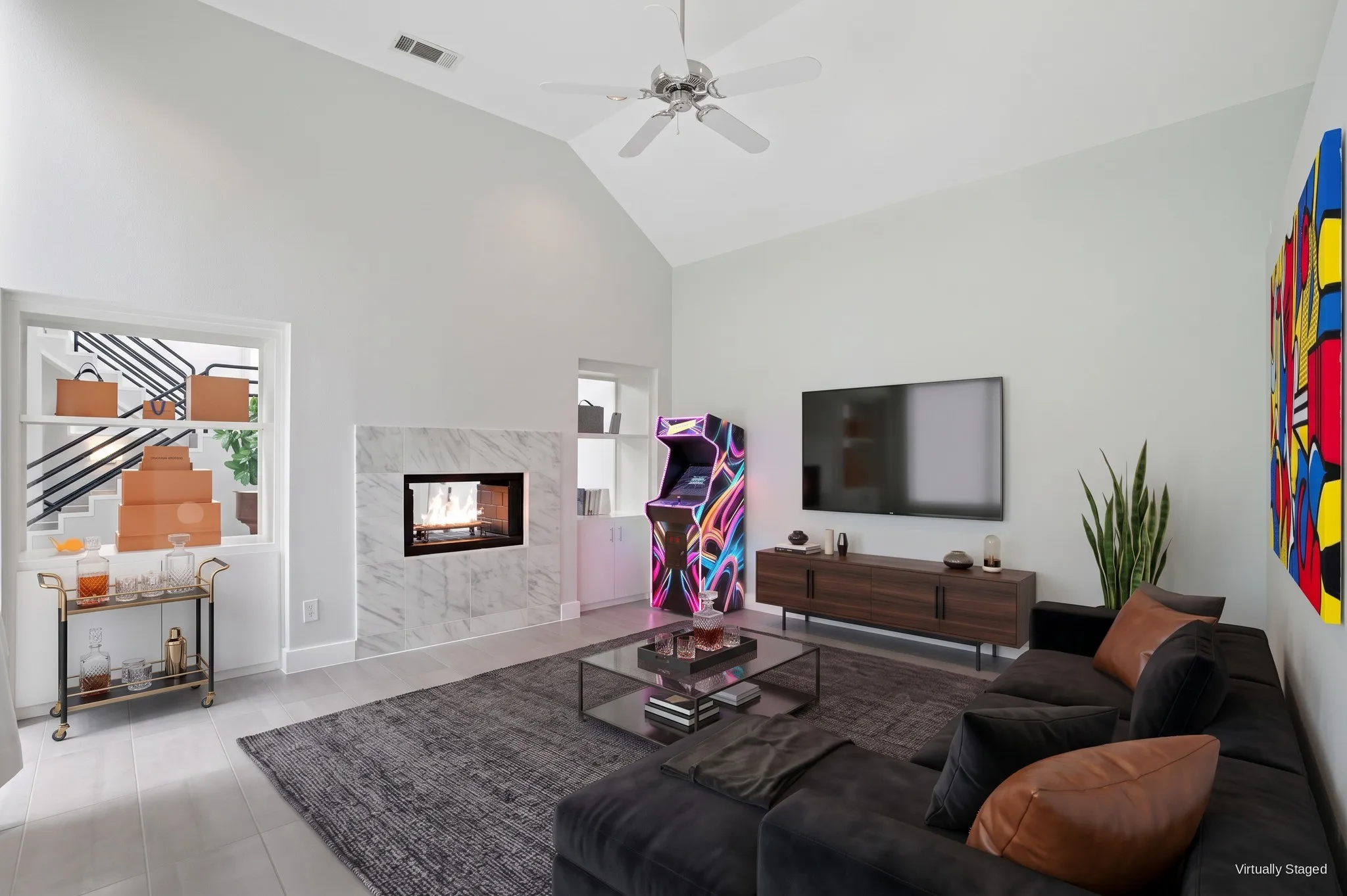 Family room with a double-sided marble gas fireplace that also opens to the stairwell, plus built-in storage. Virtually staged.