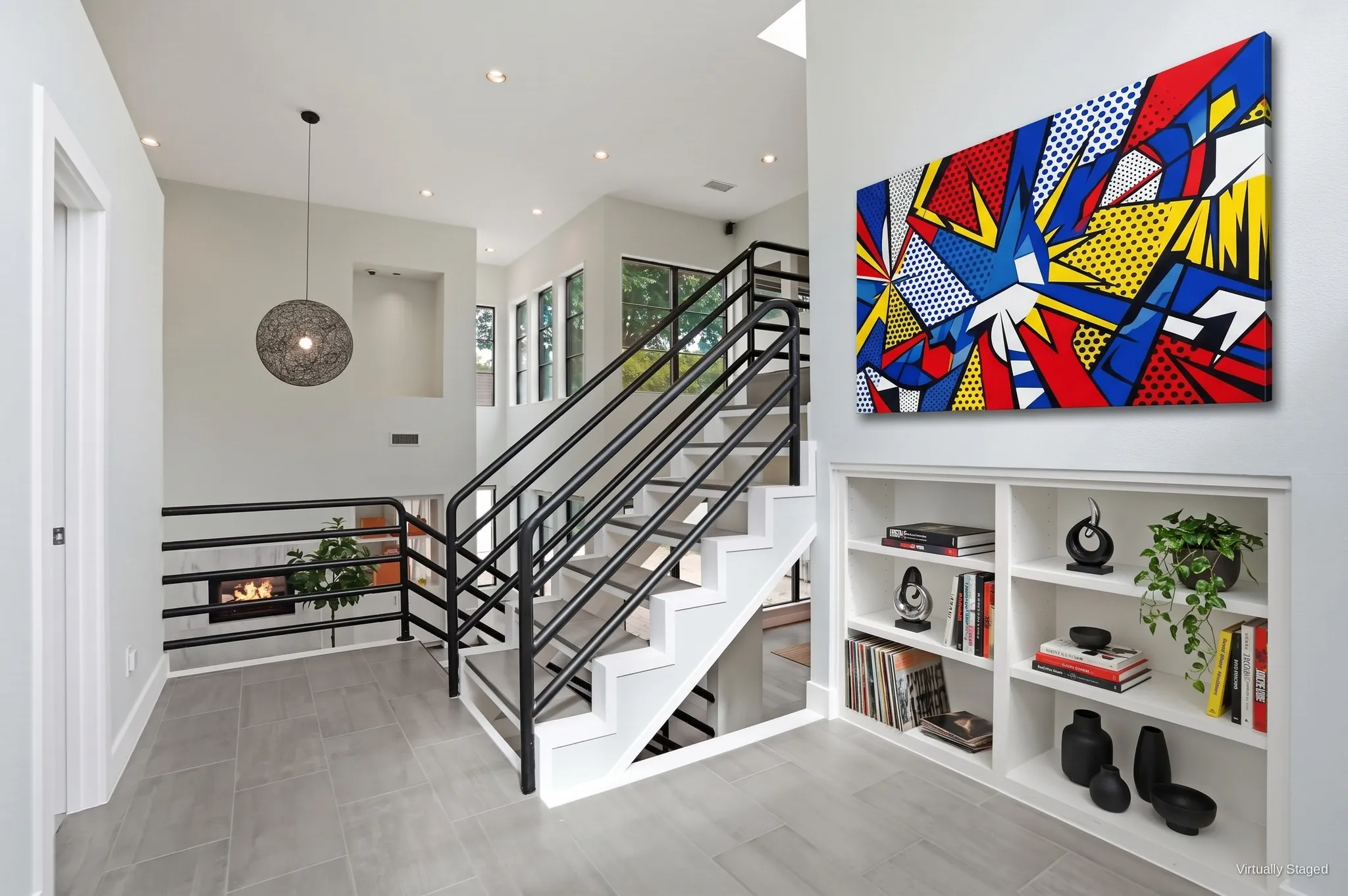 Upper landing with built-in bookshelves, a globe pendant, and an open staircase to the third-floor bedrooms. Virtually staged.