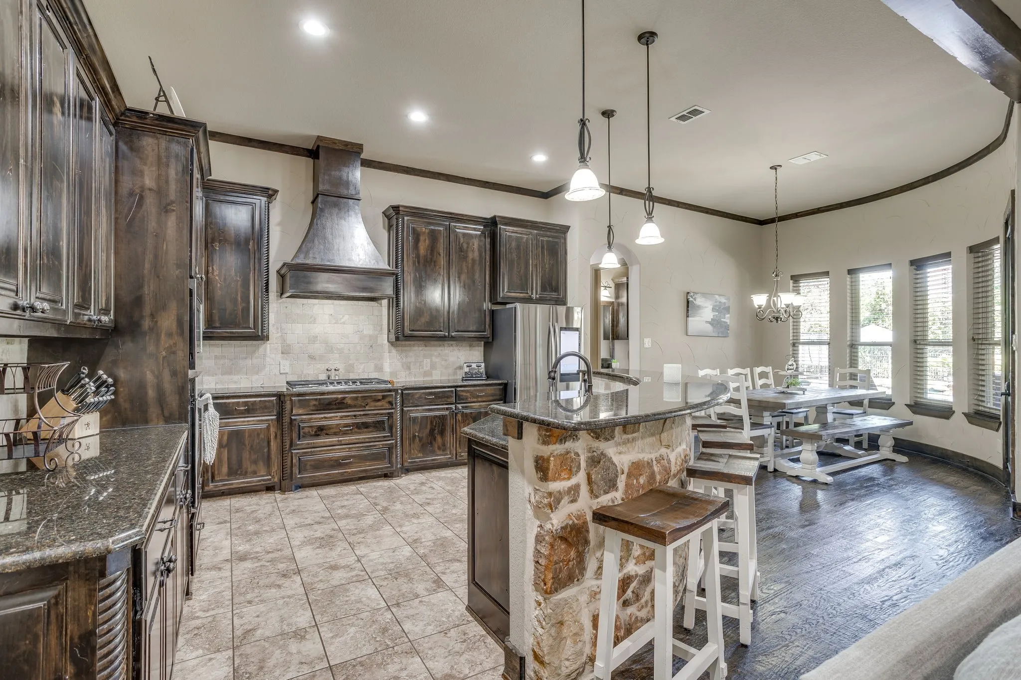 The kitchen includes granite counters, custom cabinetry, stainless steal appliances, gas stove top, walk-in pantry, butler's panty and small wine room.