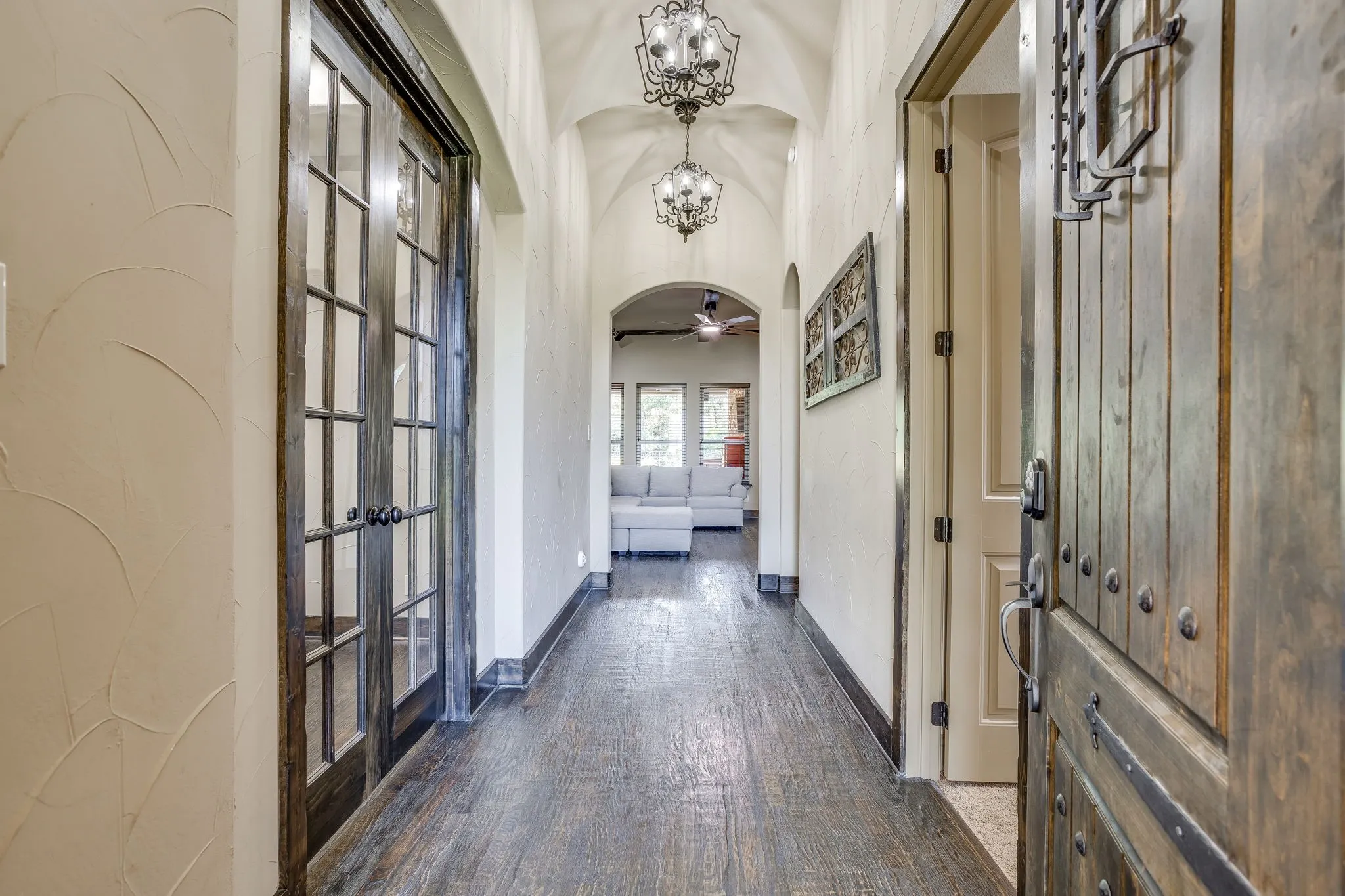 The inviting entry with handscraped wood floors, groin vault ceiling and decorative lighting.