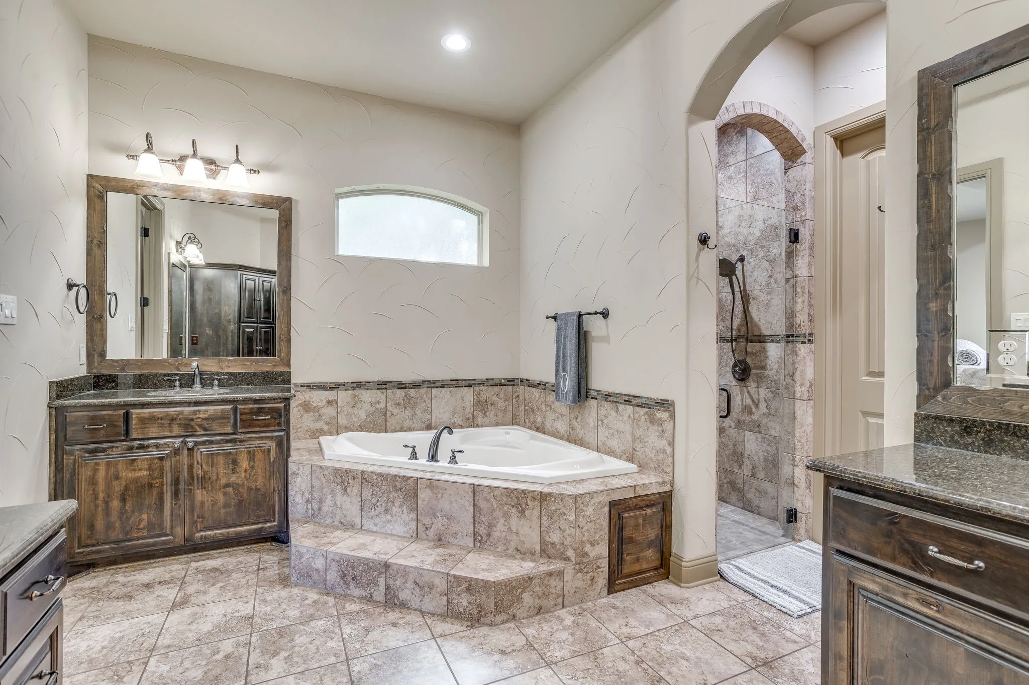 The primary bath features double vanities, a jetted tub, separate walk-in shower & large walk-in closet.