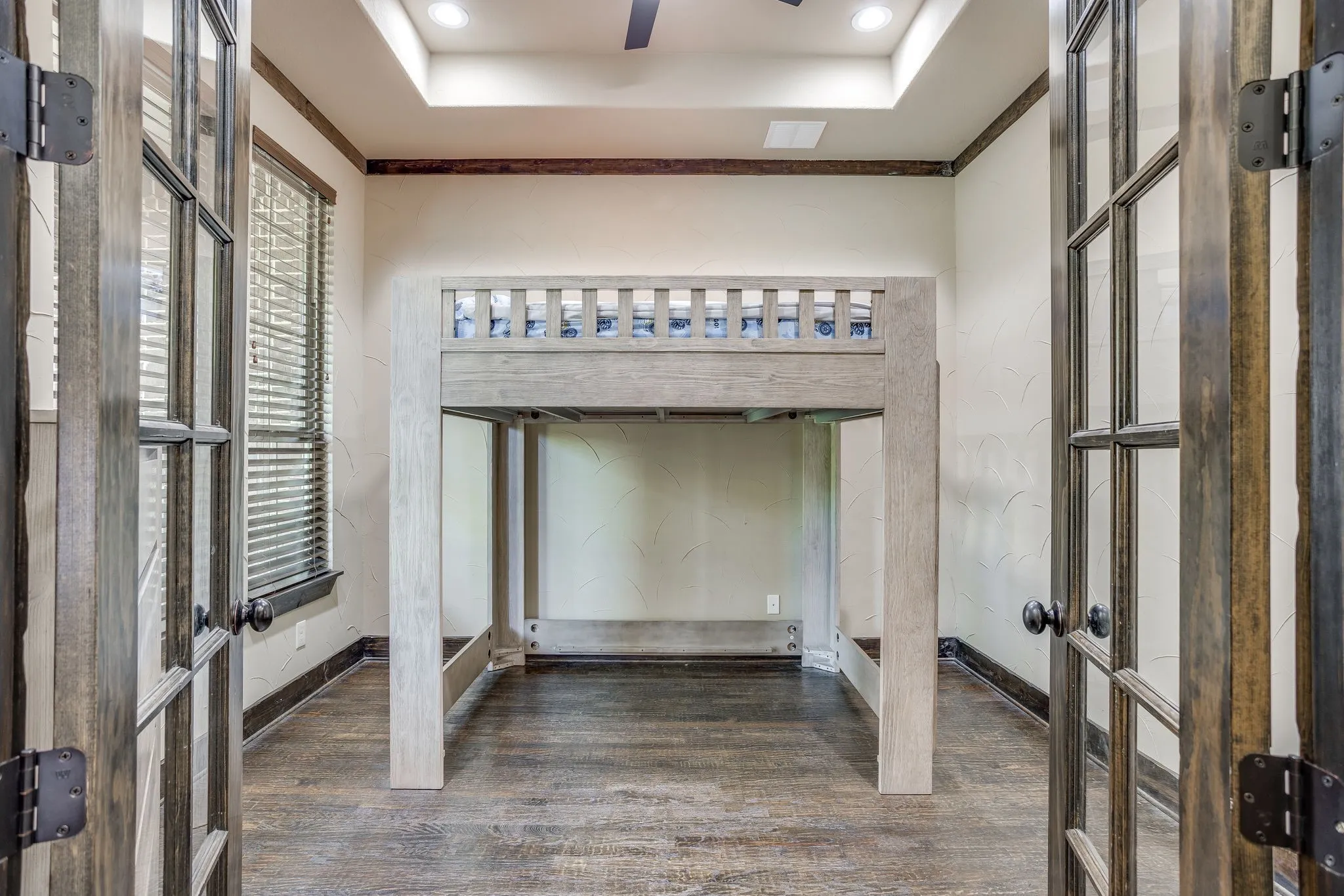 The office is currently being used as a bedroom and has french doors and a tray ceiling.