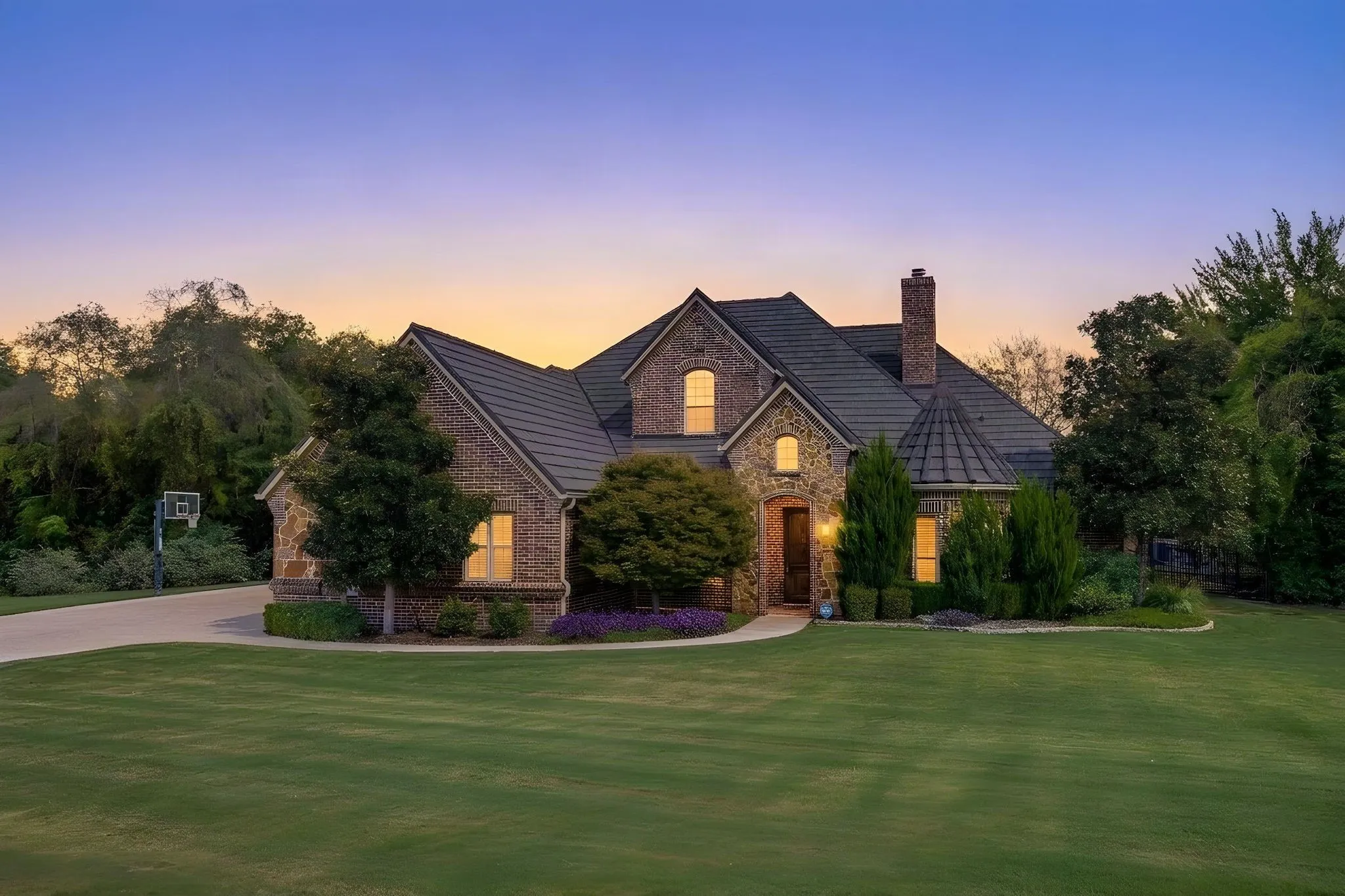 Custom home with attached 3-car garage, beautiful landscaping and inviting curb appeal