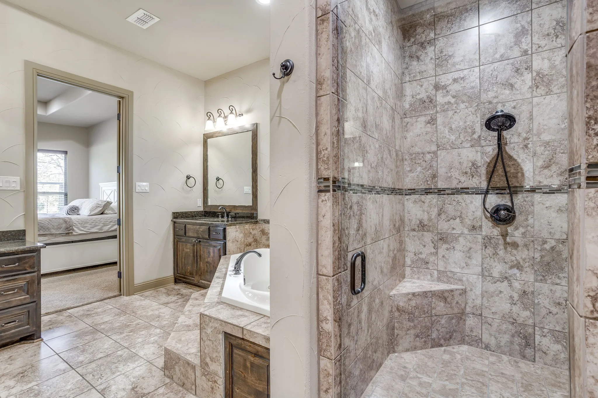 The primary bath features double vanities, a jetted tub, separate walk-in shower & large walk-in closet.