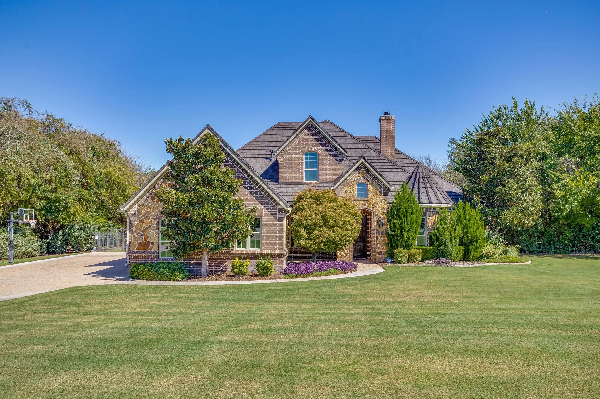 Custom home with attached 3-car garage, beautiful landscaping and inviting curb appeal