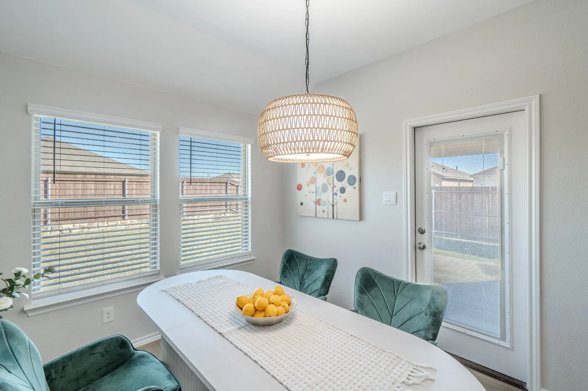 Bright interior with two windows, a light fixture, and a glass-paneled door