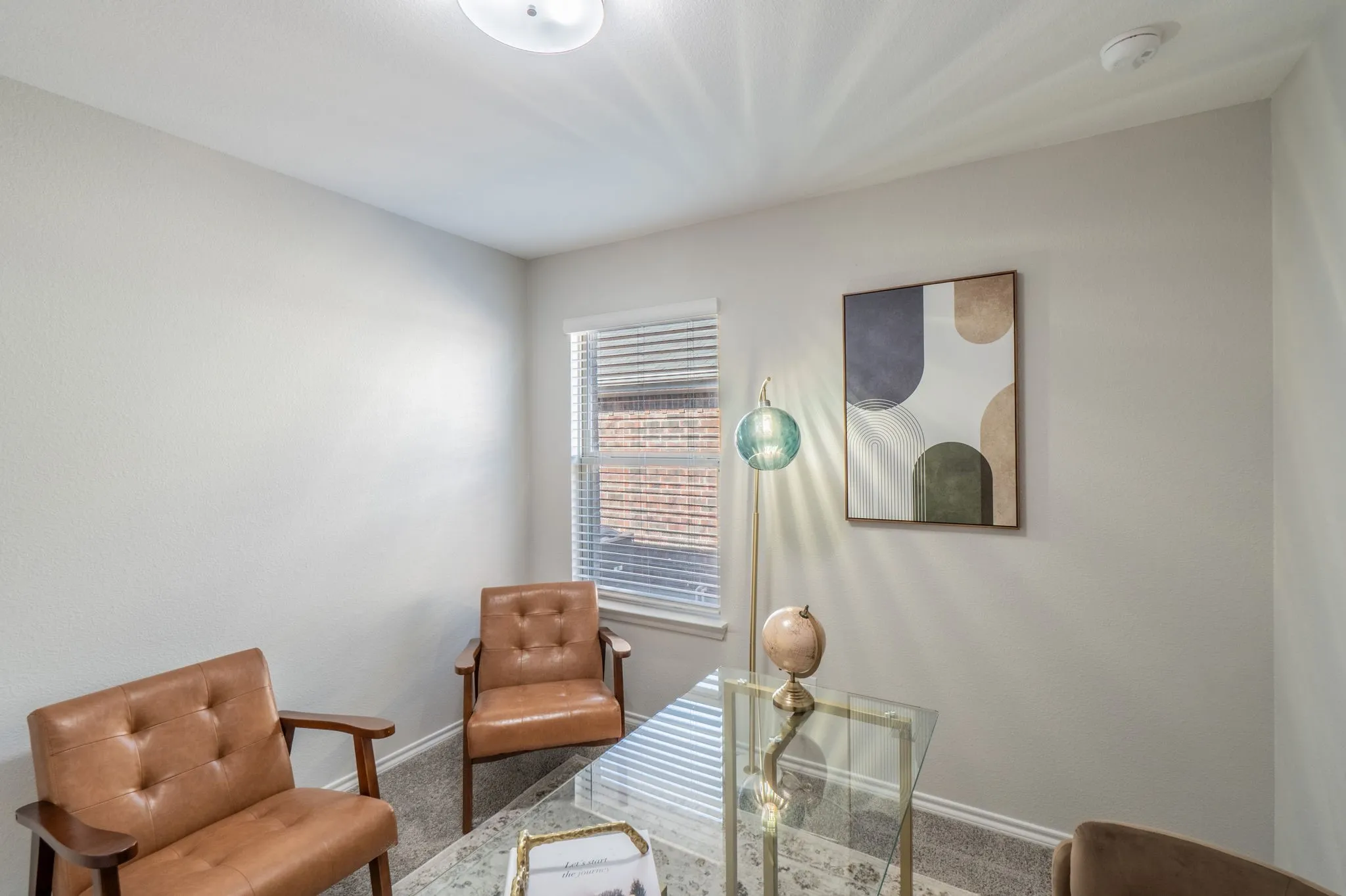 Recessed lighting illuminates neutral-toned walls and carpeted flooring