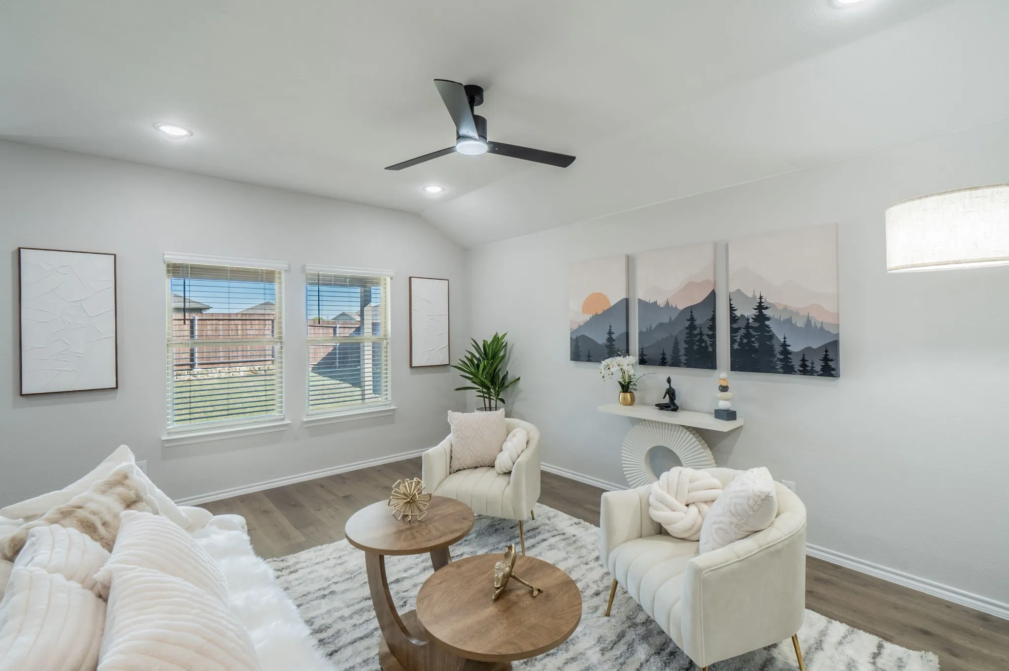 Vaulted ceiling with recessed lighting, wood-finish flooring, and a contemporary ceiling fan