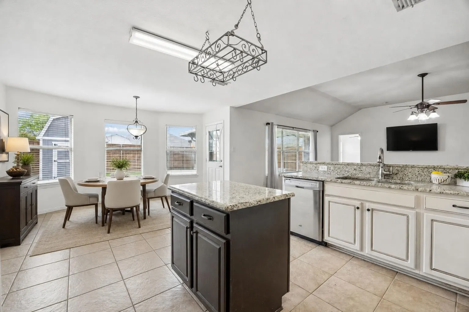 Open concept kitchen is open to dining and living area and views of backyard.