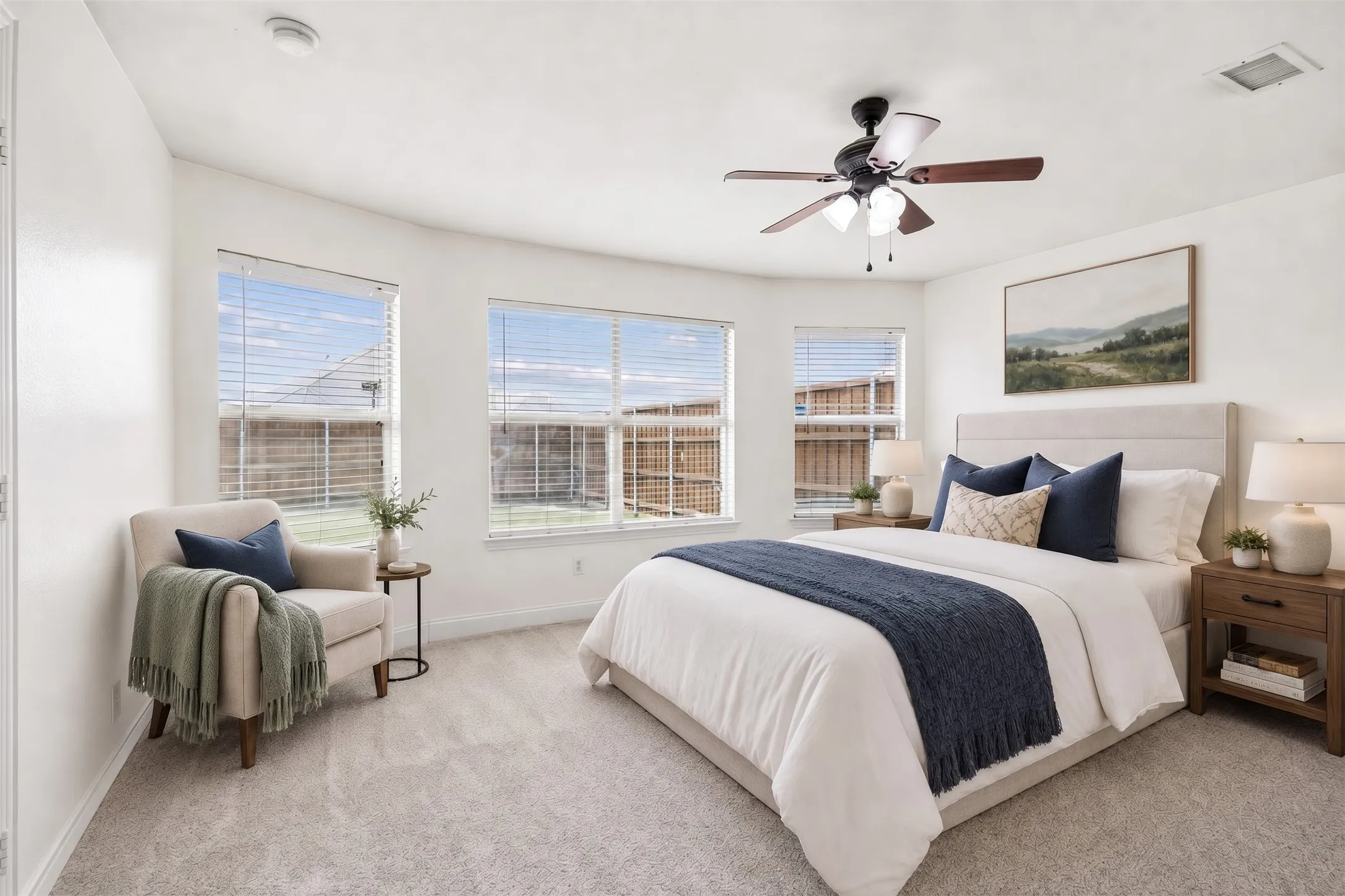 Spacious primary bedroom with natural light and calm neutral style.