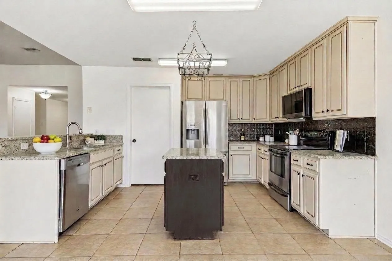 Updated kitchen with granite countertops, storage, and functional workspace.