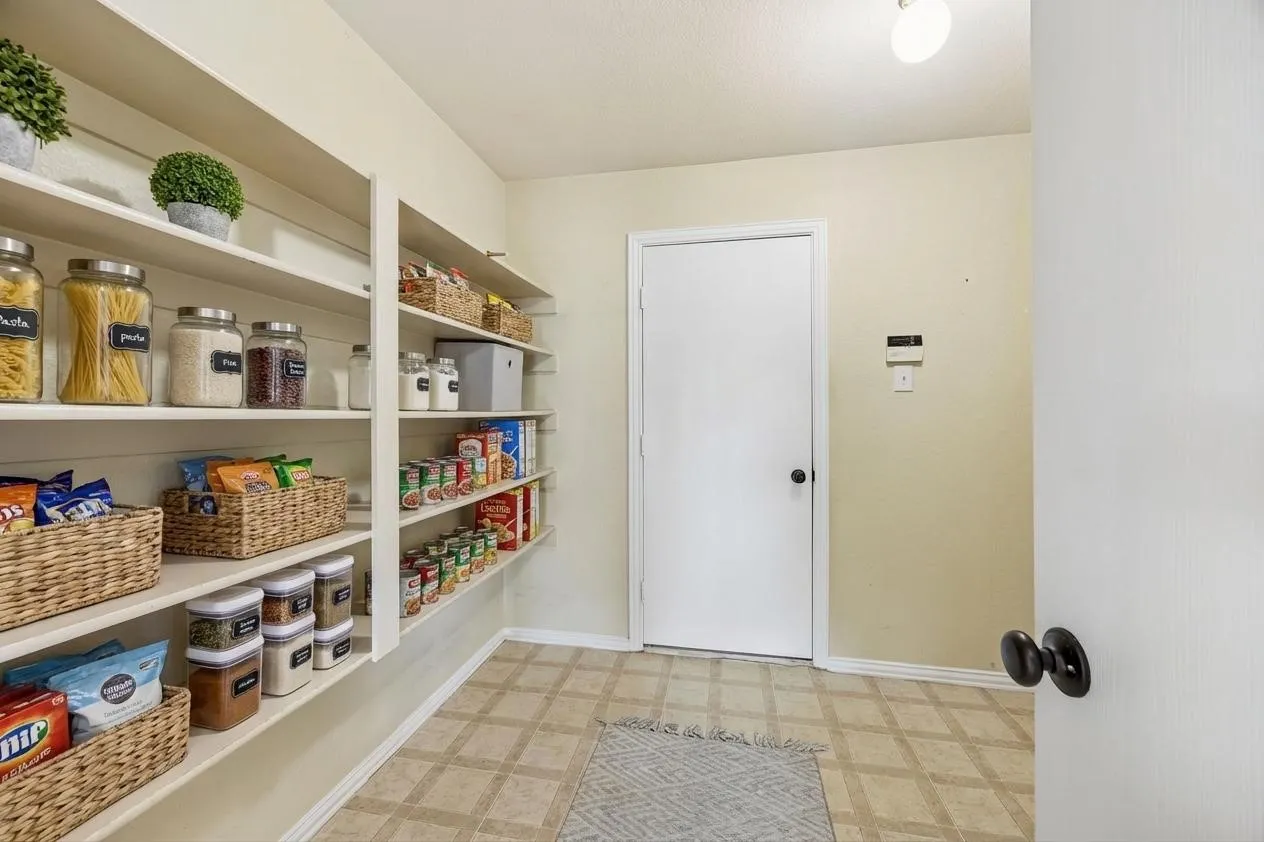 Oversized pantry also leads to large utility room.