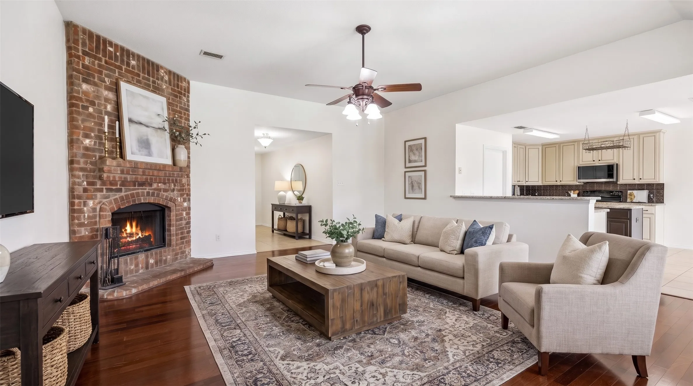 Comfortable living room with fireplace, natural light, and open flow.