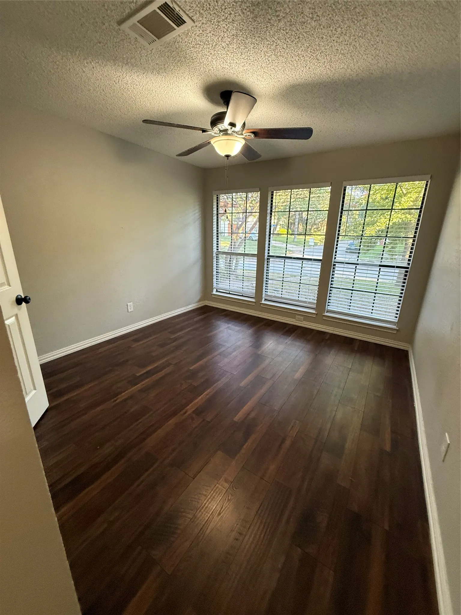Rich wood-finish flooring complemented by neutral wall tones