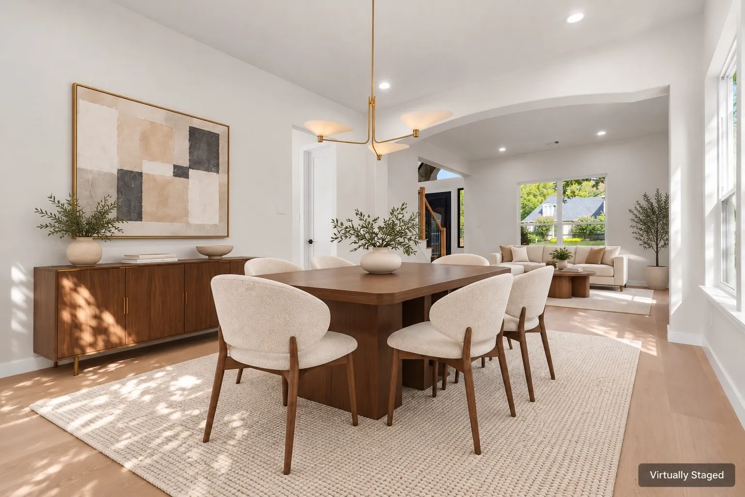 Light wood-finish flooring throughout, featuring a dining area with a contemporary chandelier