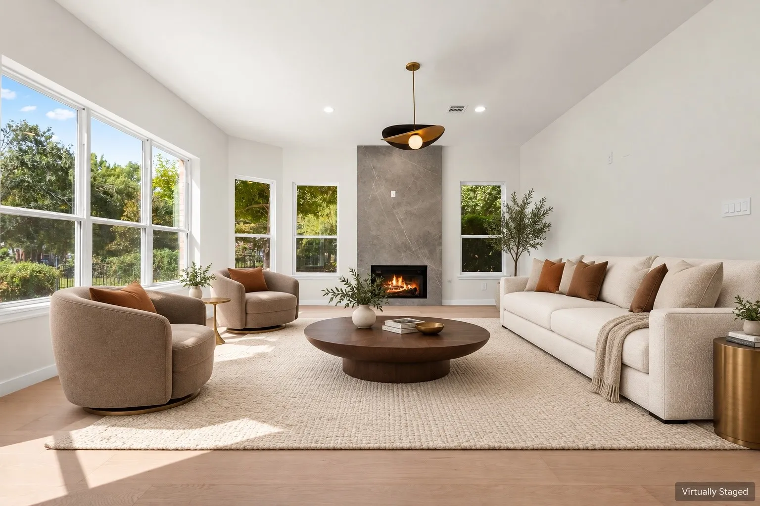 Vaulted ceiling with recessed lighting, expansive windows, a modern fireplace with a stone-finish surround, and wood-finish flooring