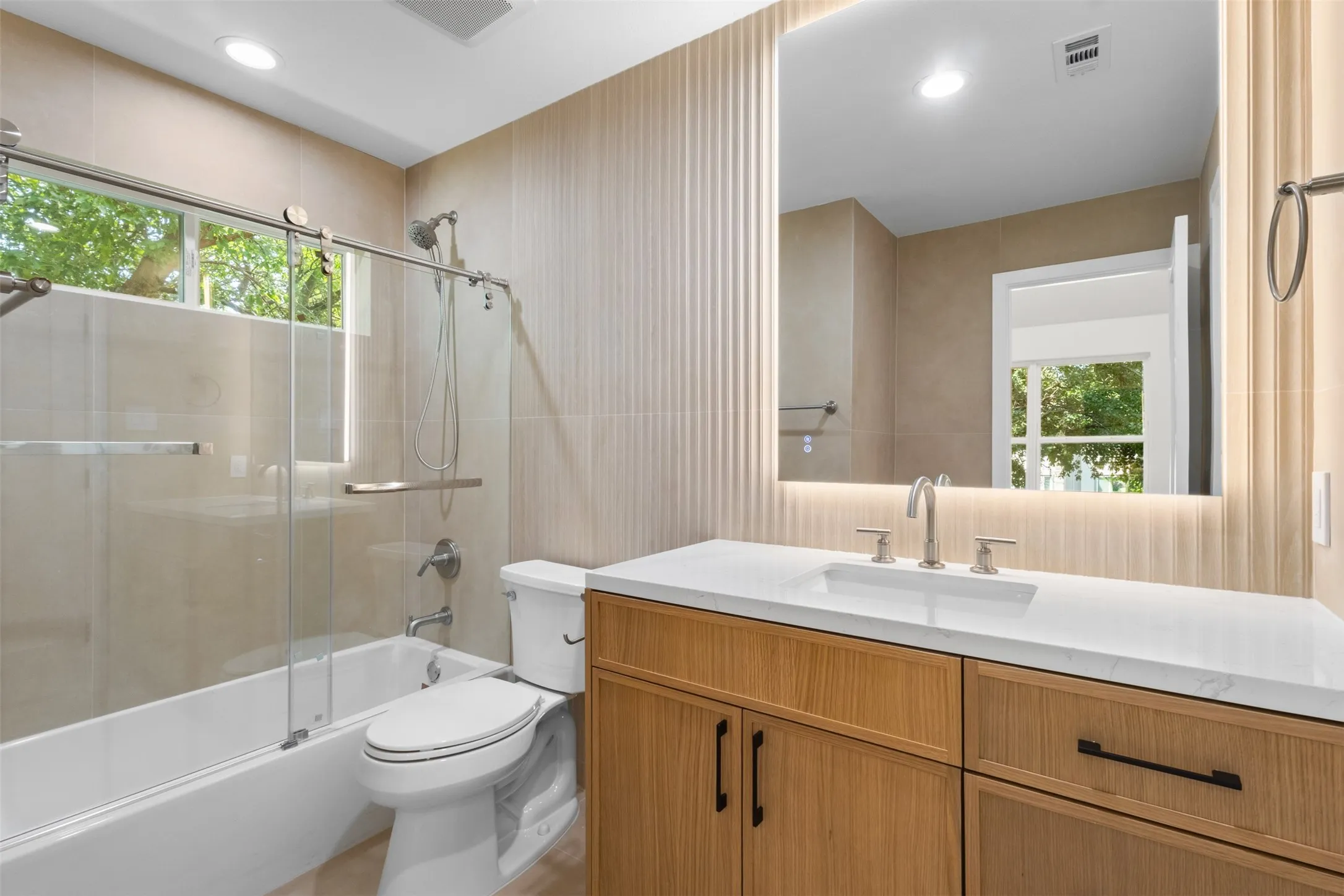 Modern vanity with a rectangular undermount sink, white countertop, and wood-finish cabinetry