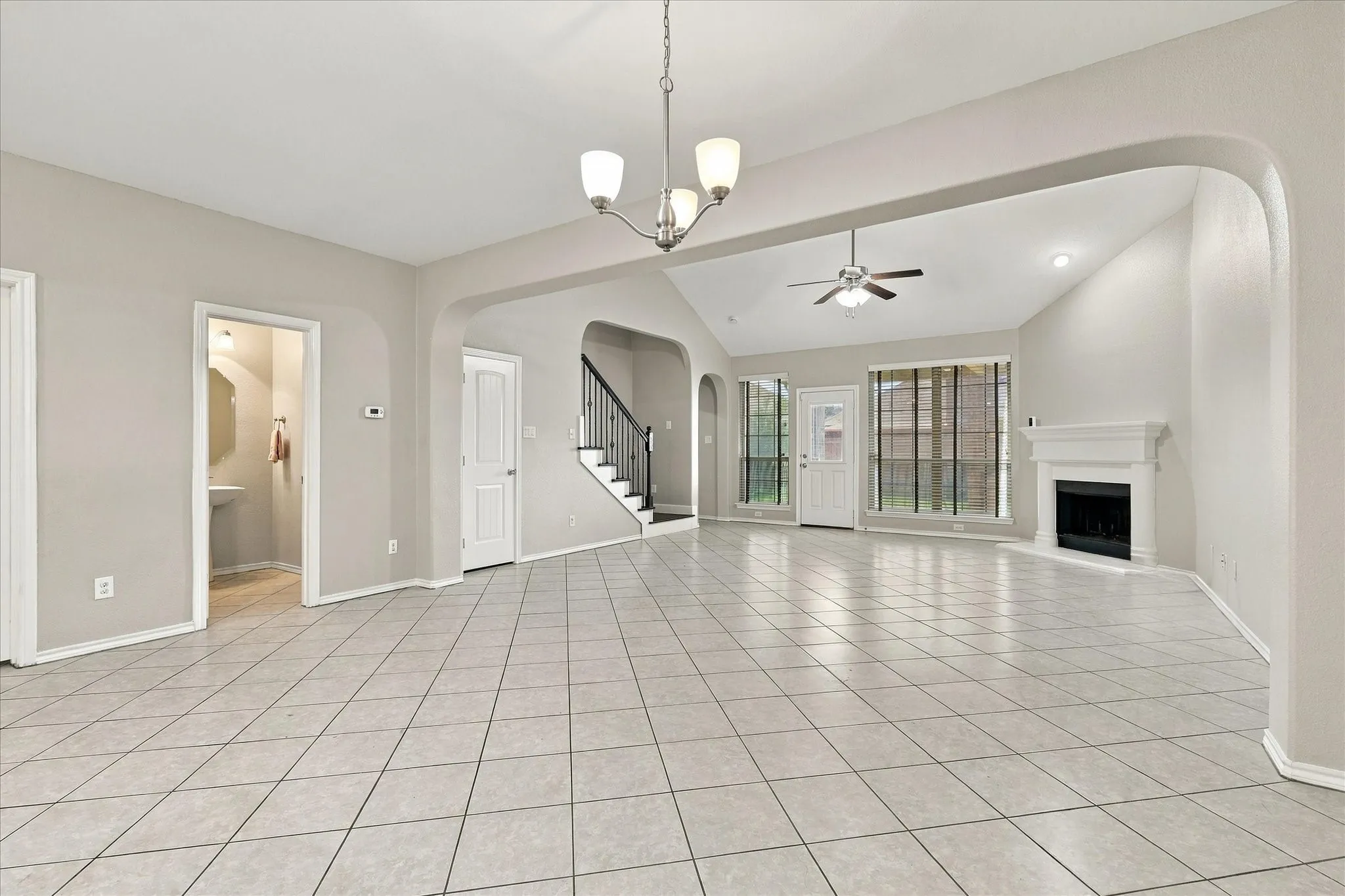 Expansive tiled flooring throughout, vaulted ceiling, built-in fireplace, and a contemporary ceiling​​‌​​​​‌​​‌‌​‌‌​​​‌‌​‌​‌​‌​​​‌​​ fan