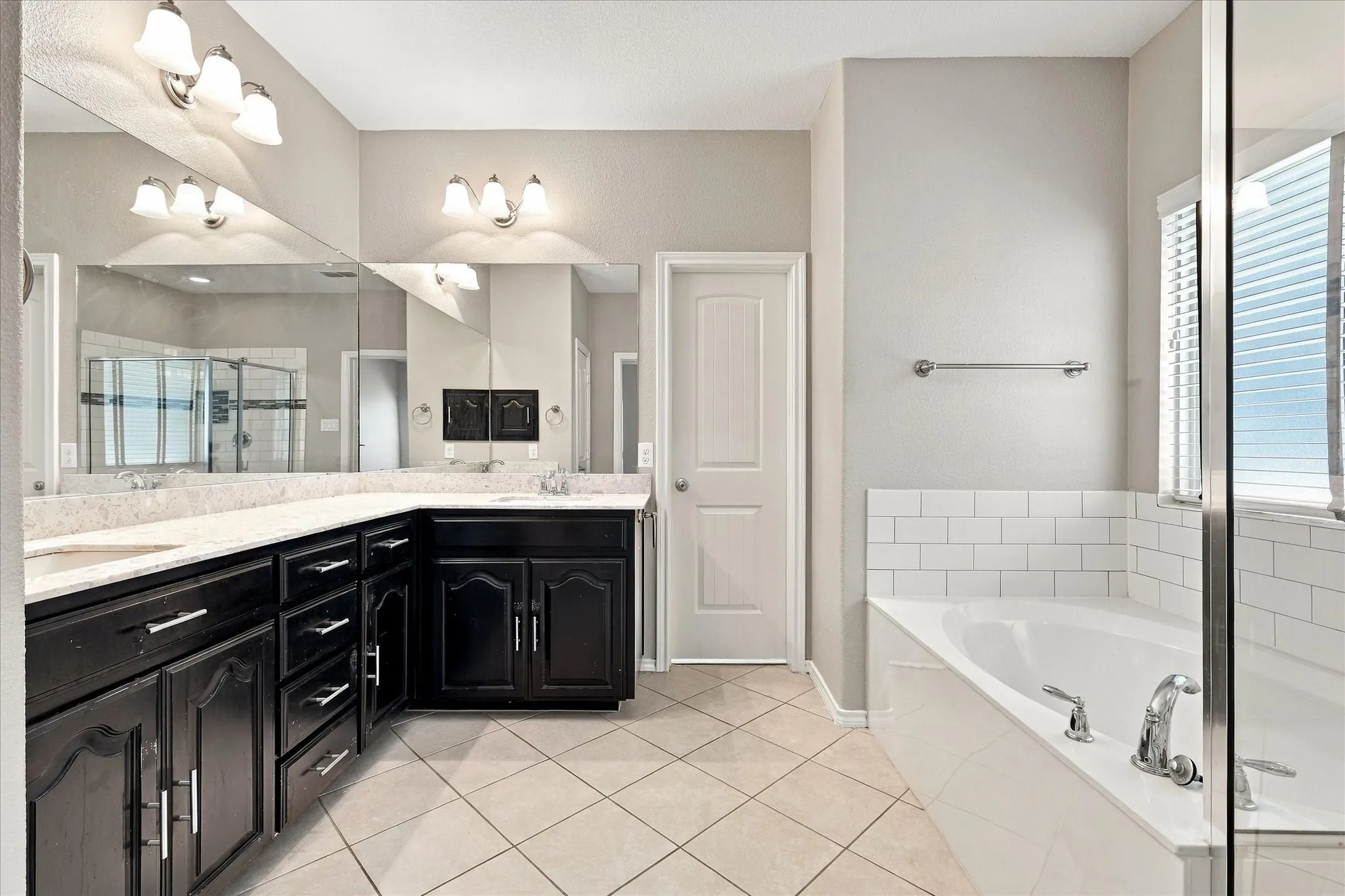 Dual vanity with dark wood-finish cabinetry and light-toned countertops