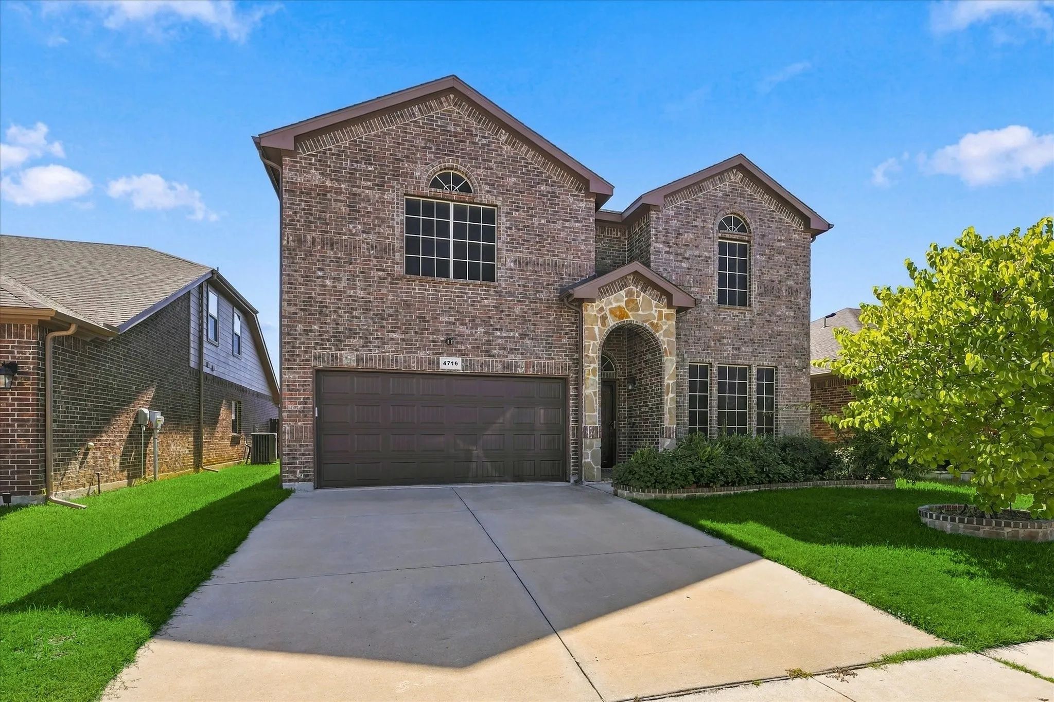 Brick and stone facade with arched entry