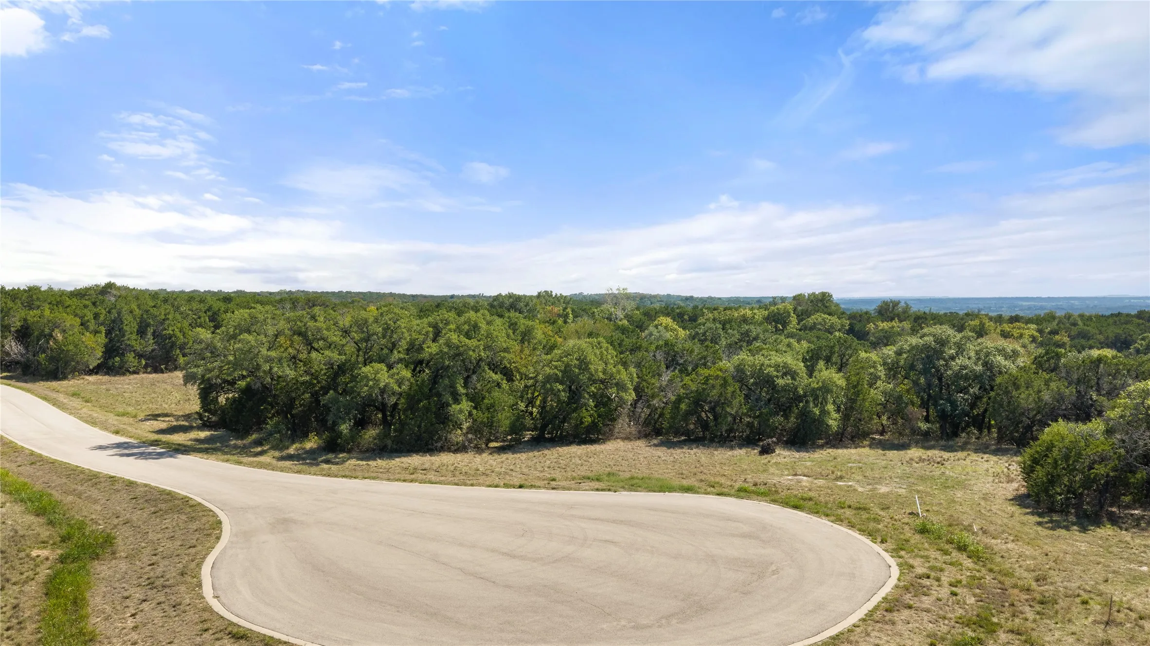 Paved cul-de-sac with surrounding natural landscaping