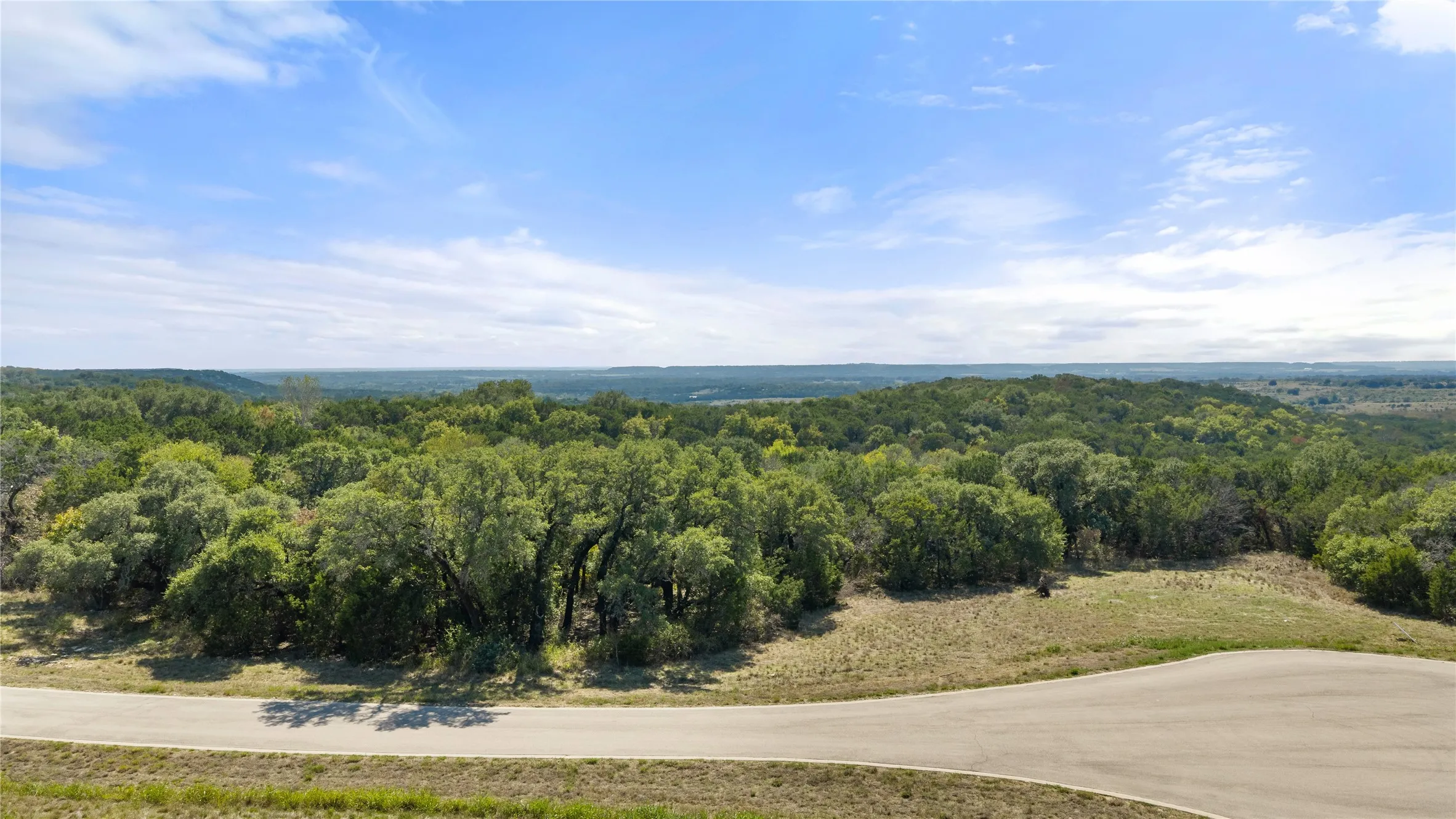 Scenic acreage featuring mature hardwood trees, open pastureland, and expansive vistas across rolling countryside