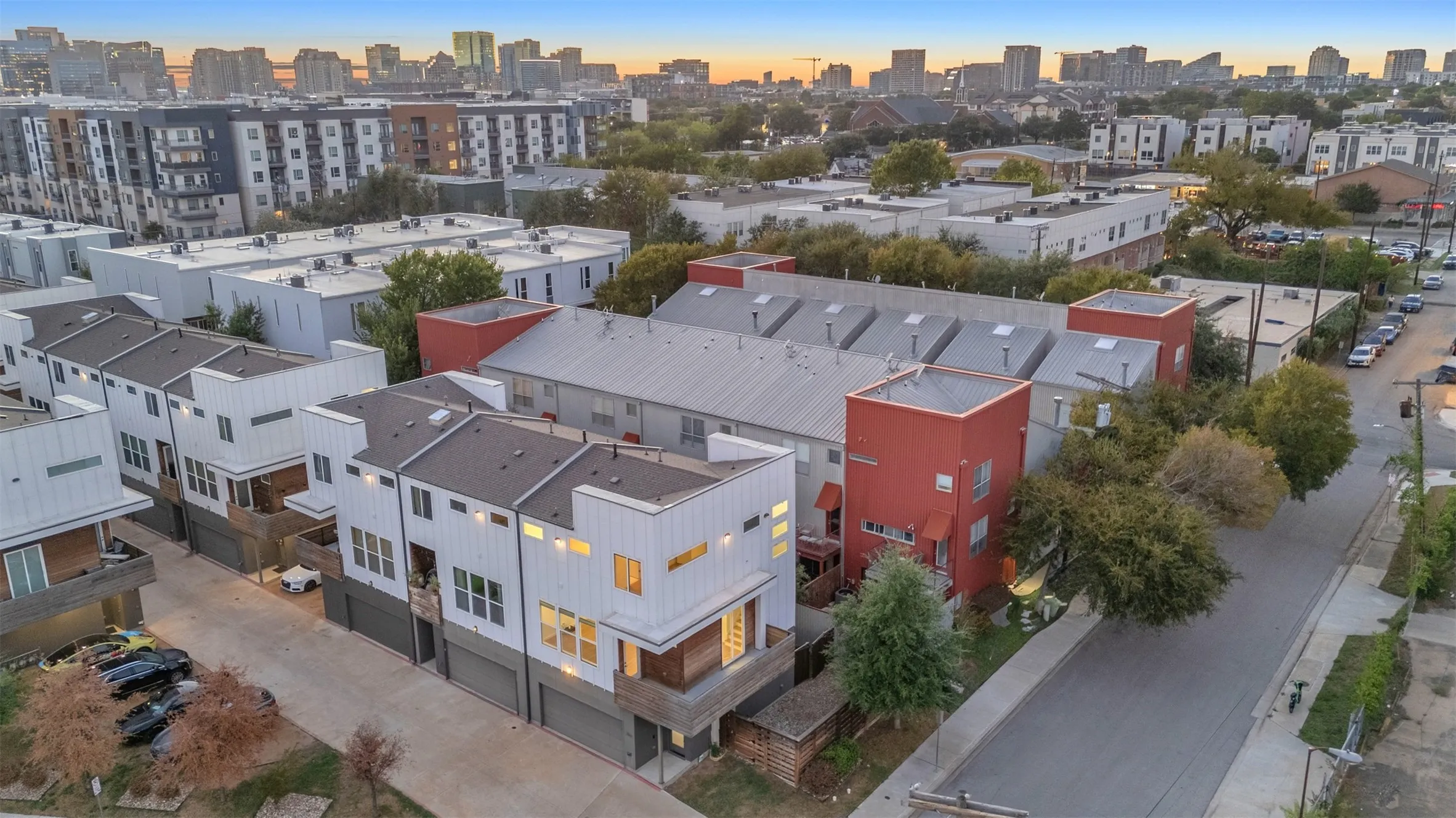 Aerial view of the row of condos, the shared garage drive and the surrounding East Dallas neighborhood
