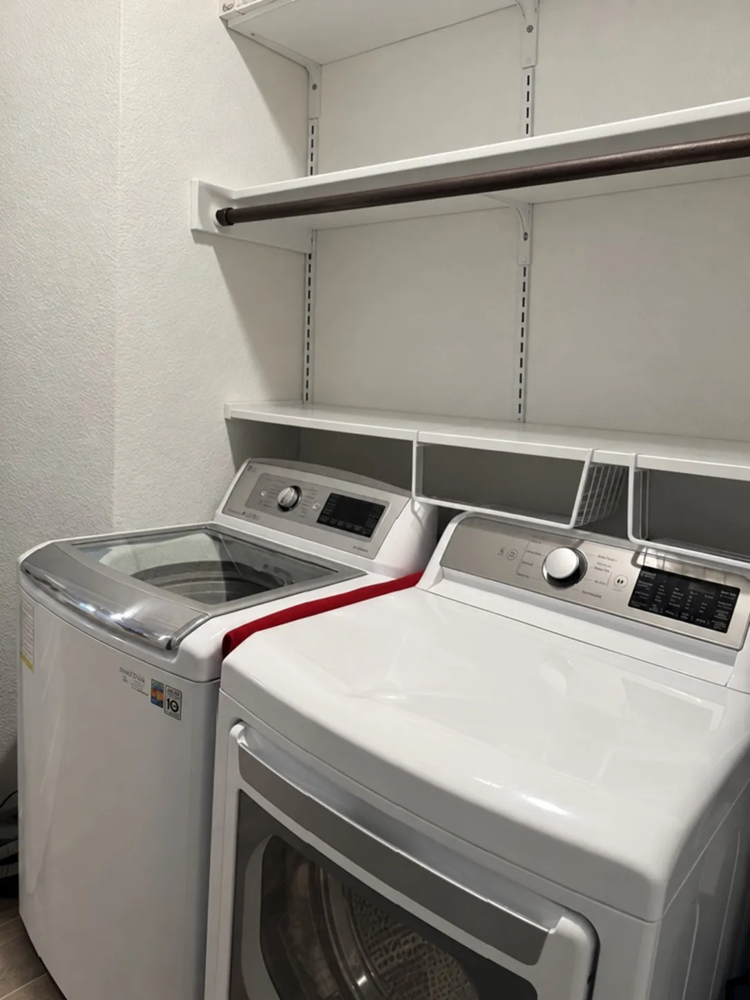 Built-in white shelving system with a hanging rod