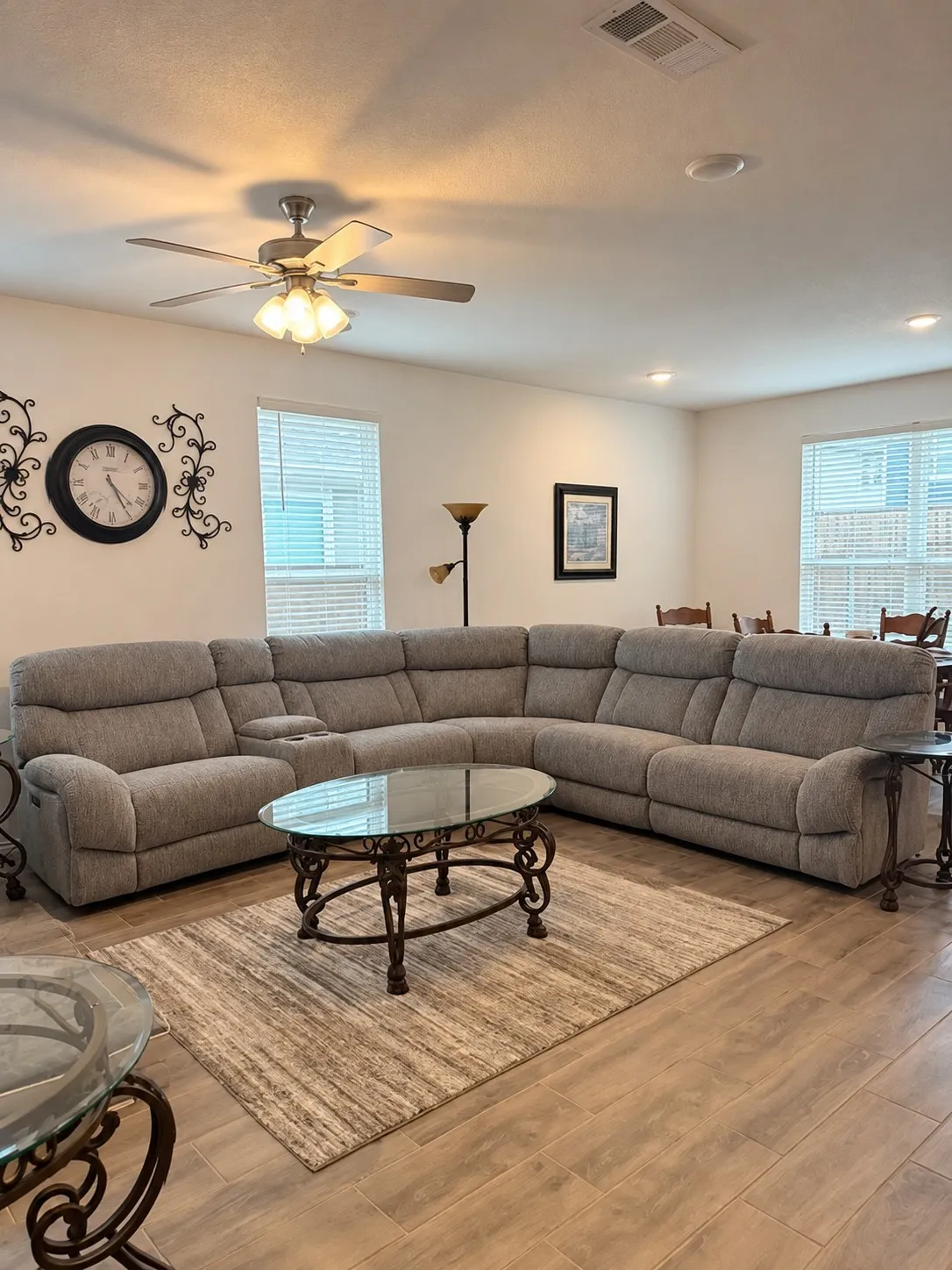 Recessed lighting, ceiling fan with light fixture, multiple windows with blinds, and wood-finish flooring throughout