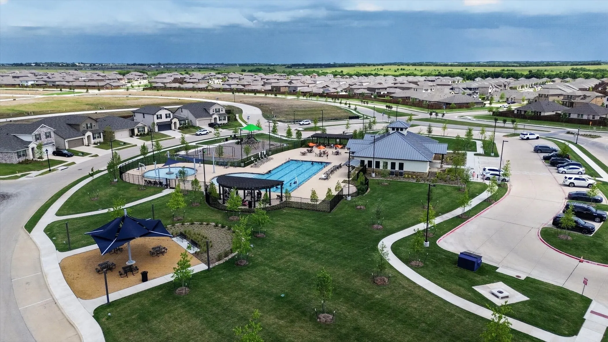 Community amenities featuring a swimming pool, clubhouse, playground, and manicured green spaces