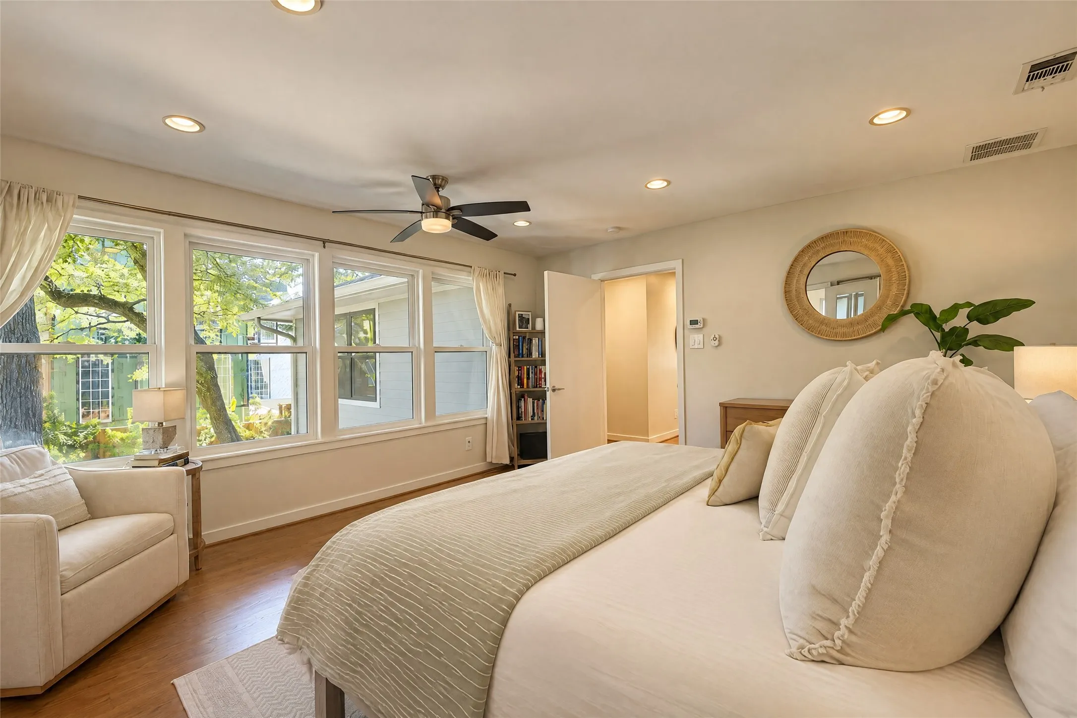 Recessed lighting, wood-finish flooring, ceiling fan, and multiple windows