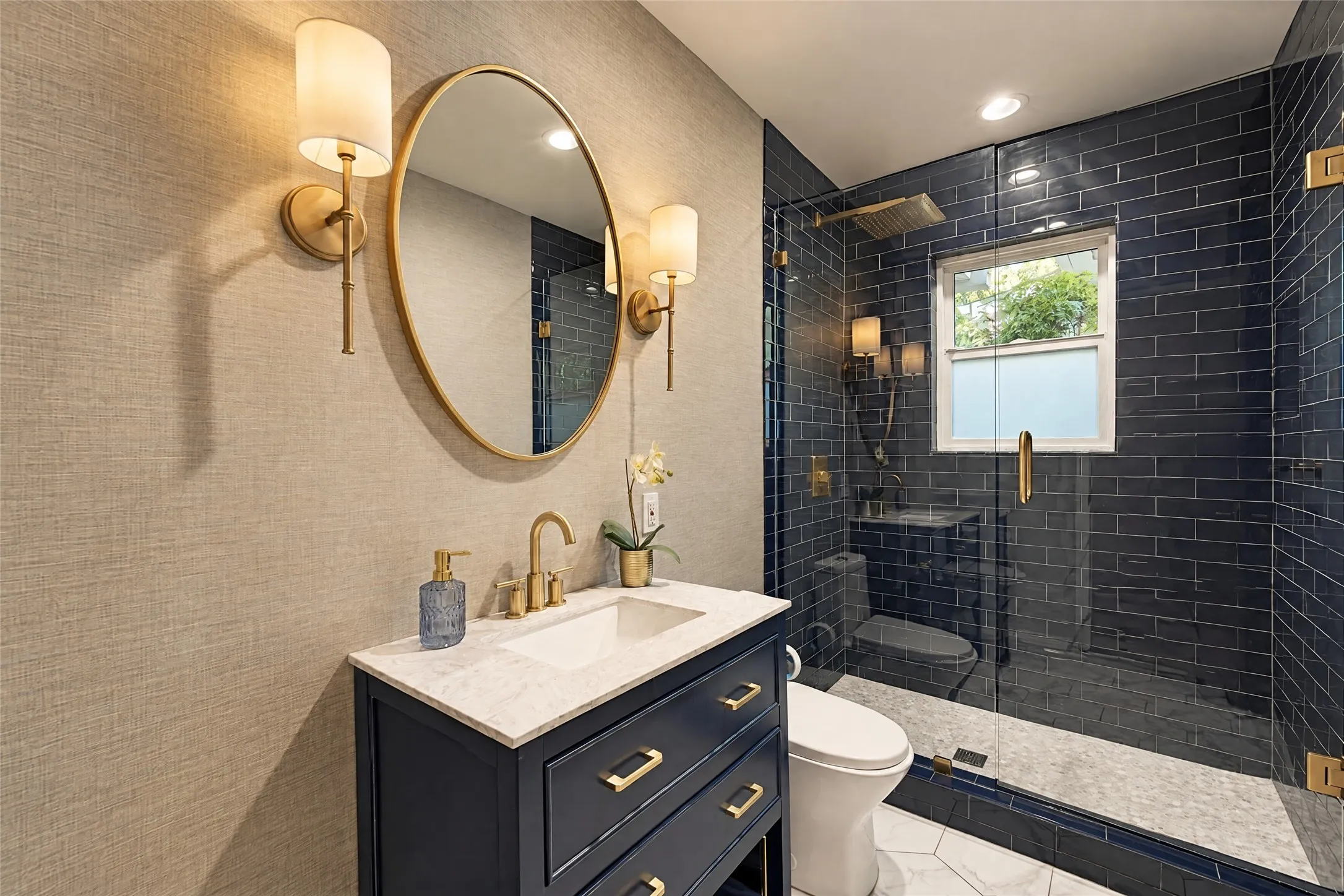 Vanity with a white countertop and gold-finish fixtures