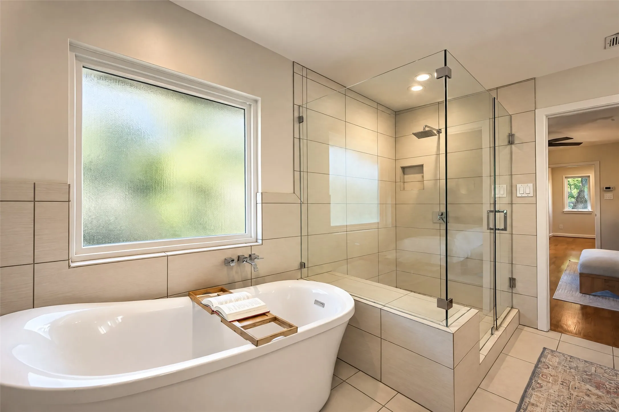 Freestanding soaking tub with wall-mounted fixtures