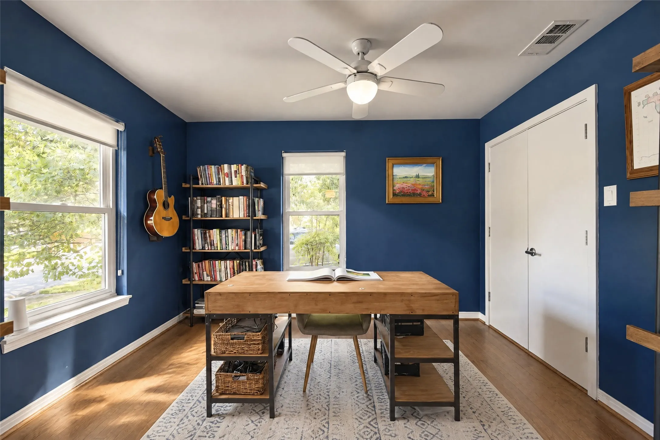 Recessed lighting with a ceiling fan, dual windows, wood-finish flooring, and built-in shelving