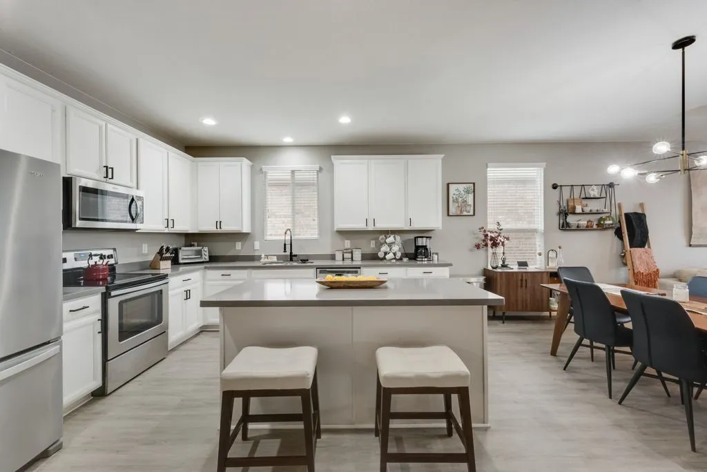 Virtually staged.  Large kitchen island and Stainless-steel appliance.