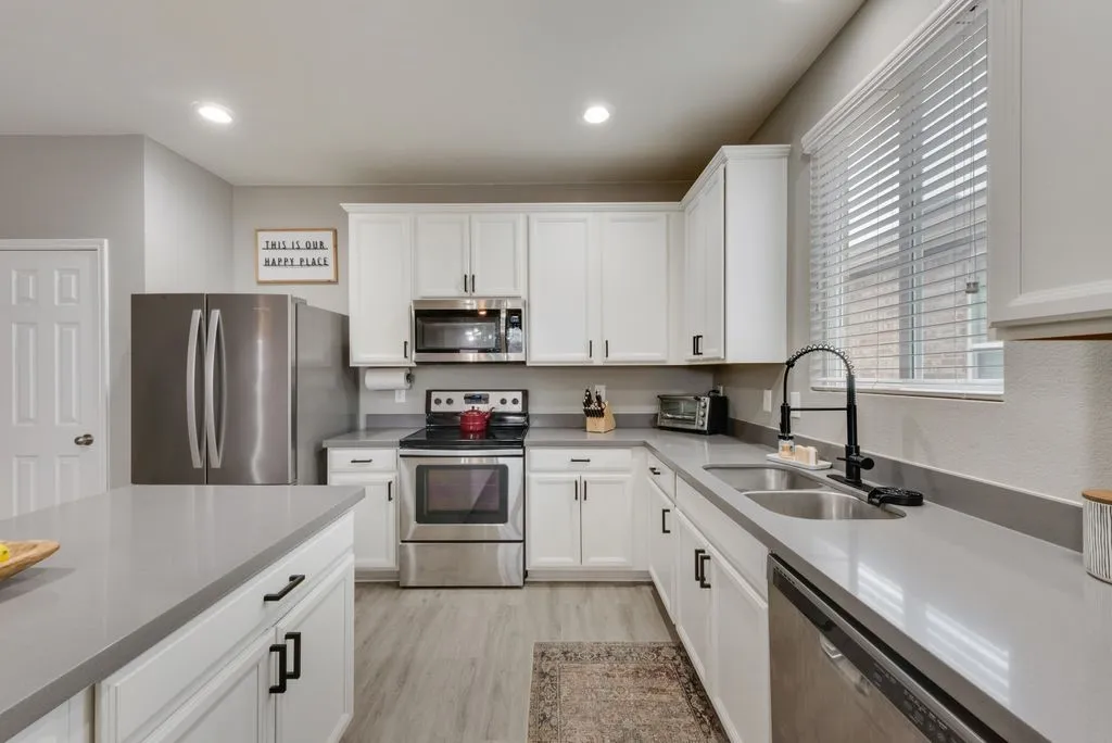 updated quartz countertops, kitchen faucet, and hardware